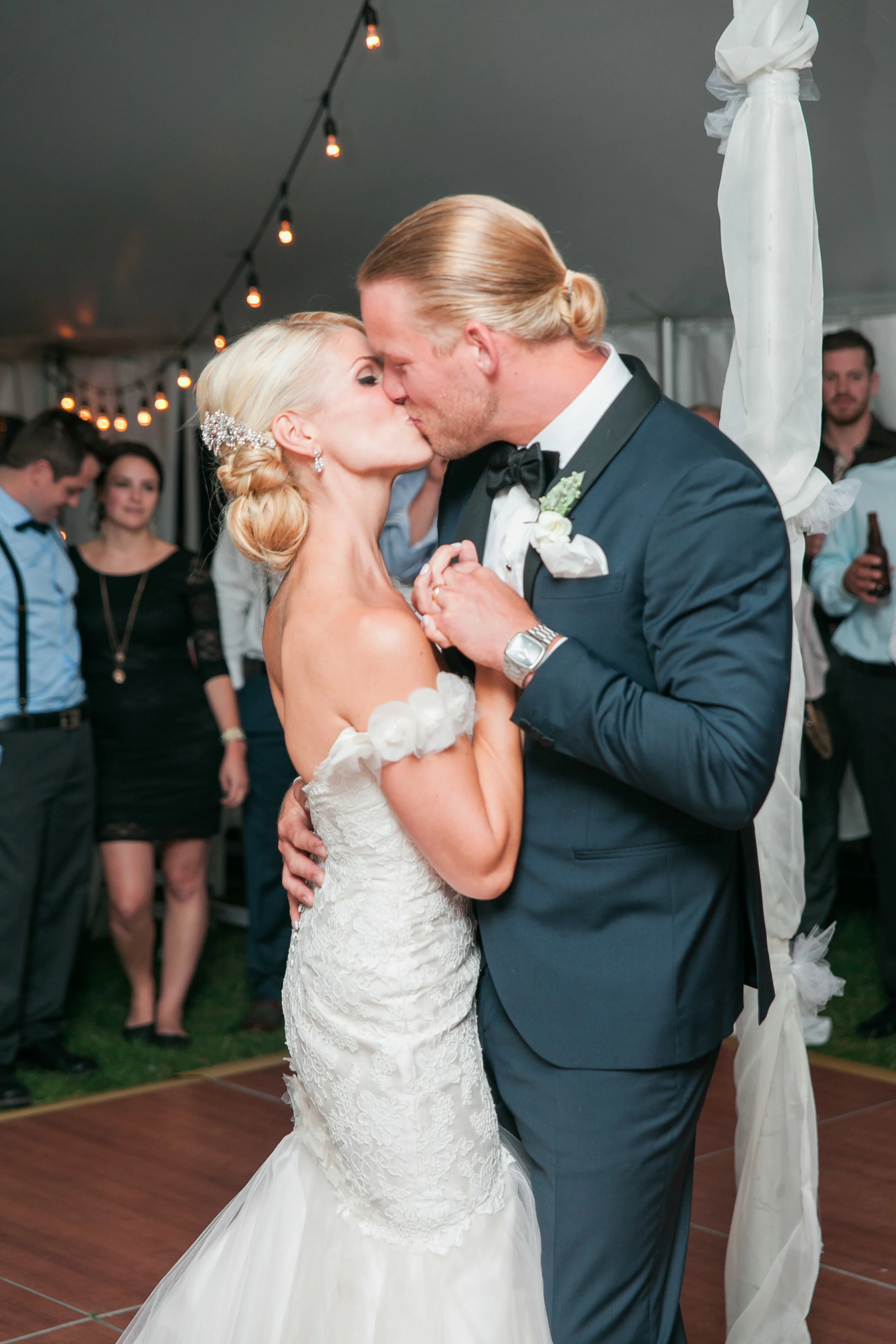 Bride and groom kissing during first dance