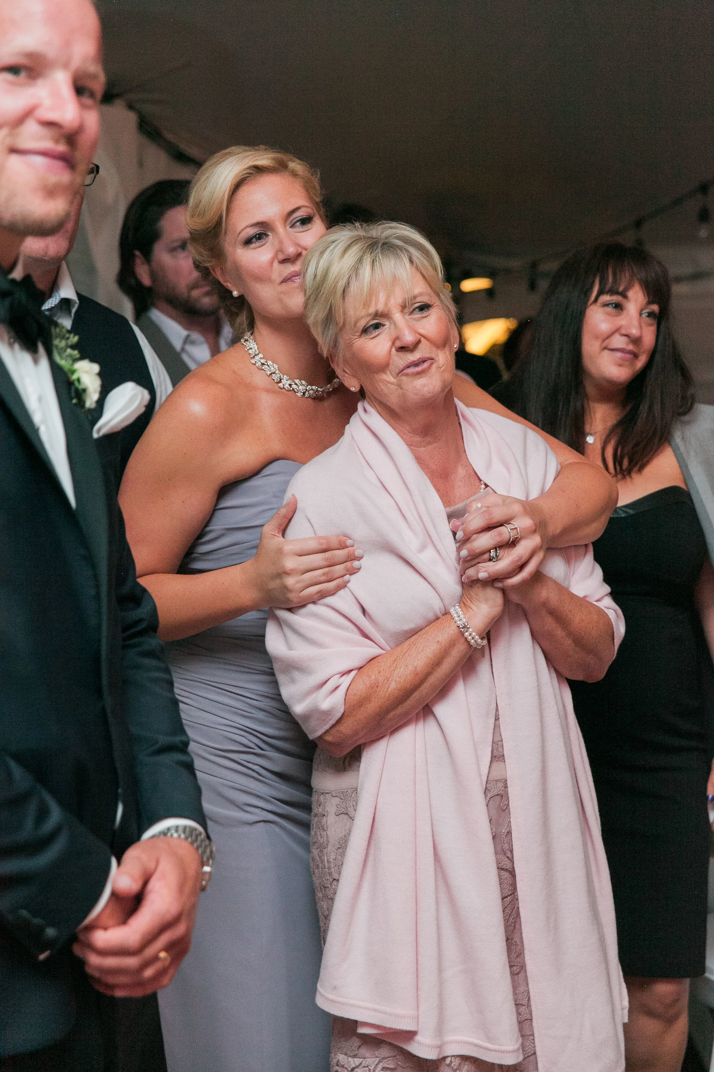 Mother of bride watching father daughter dance