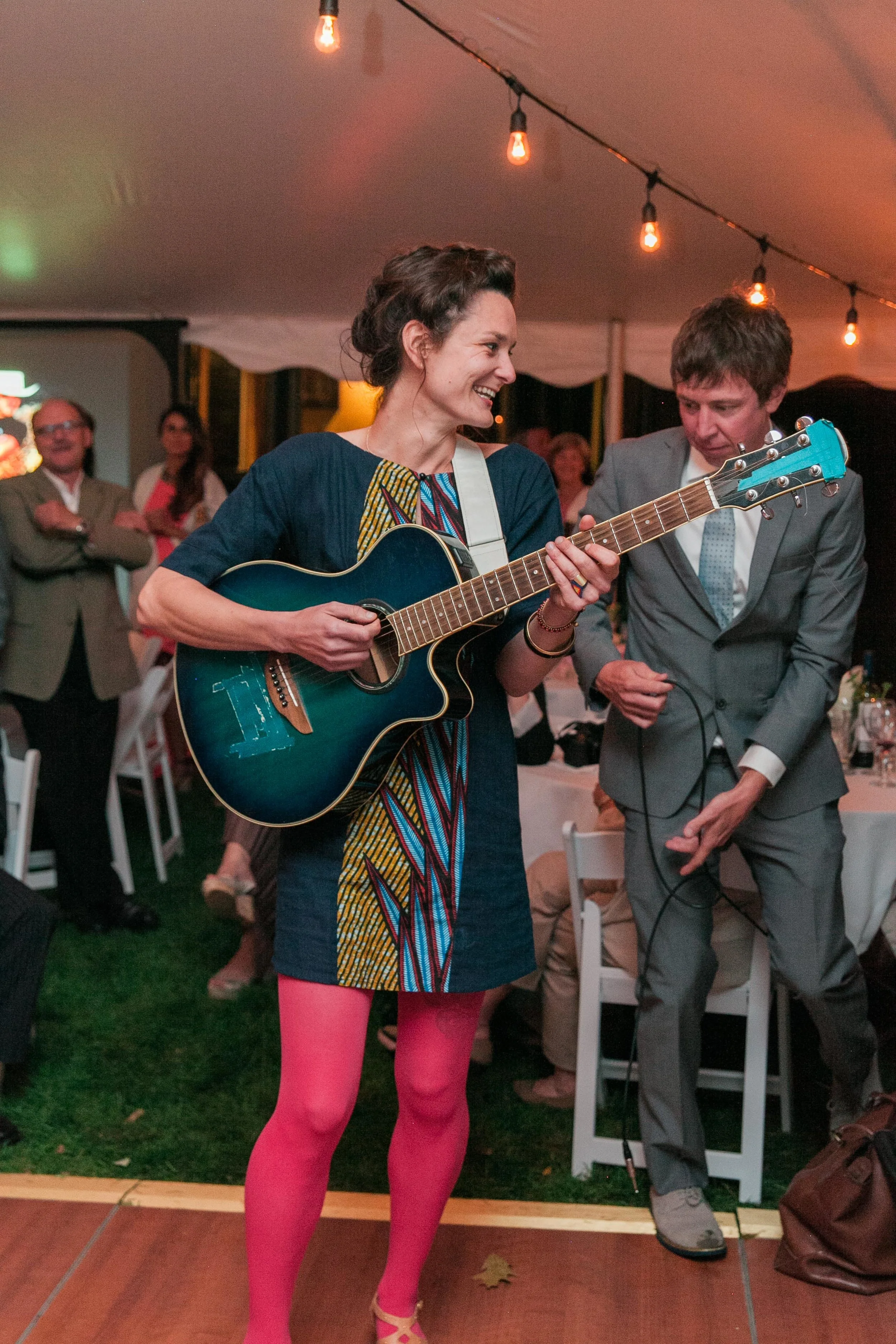 Friend playing guitar and singing at wedding
