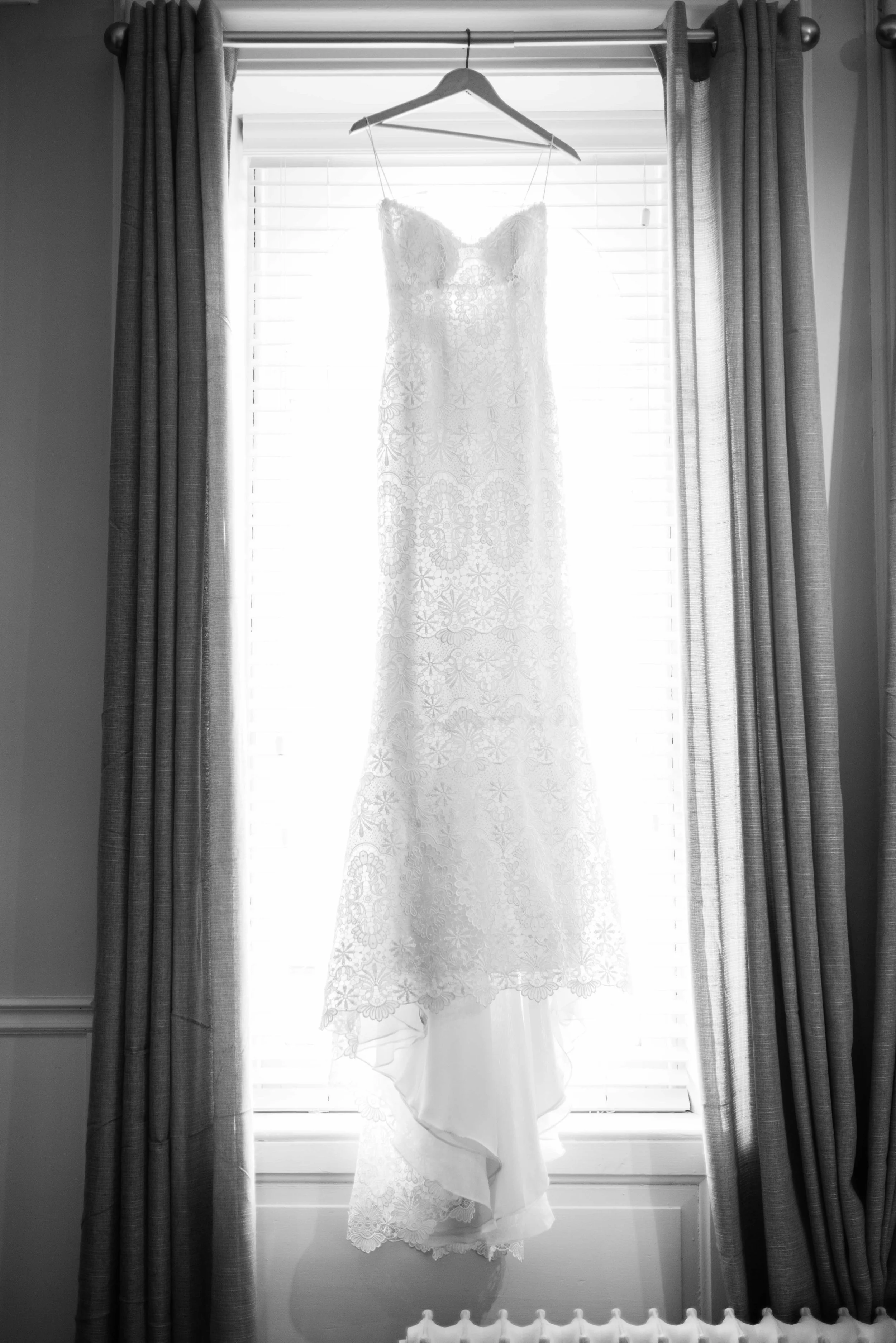 French lace wedding dress in window.