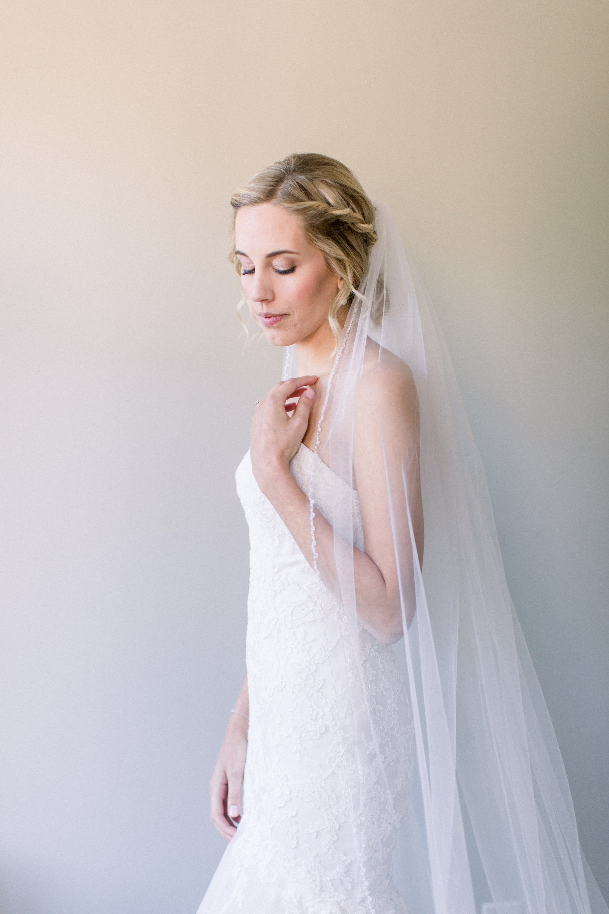 Bride wearing veil for her wedding.