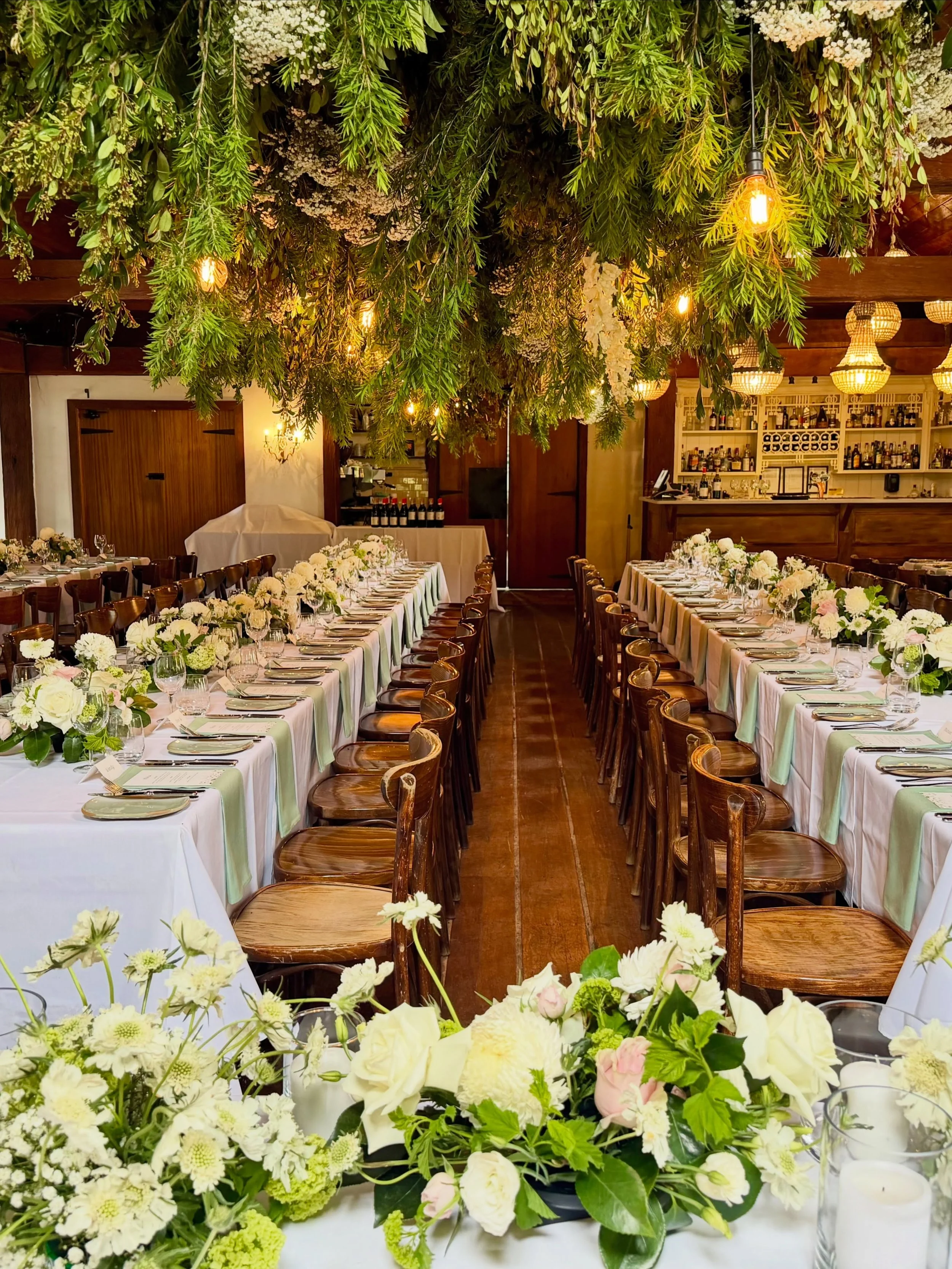 Some rooms make you stop at the door. This was one of them. ✨

Elyse + Joshua&rsquo;s reception @circa1876  transformed beneath a wild canopy of fresh cascading greenery, soft white florals and warm glowing light.

Layers of sage, white and blush fil