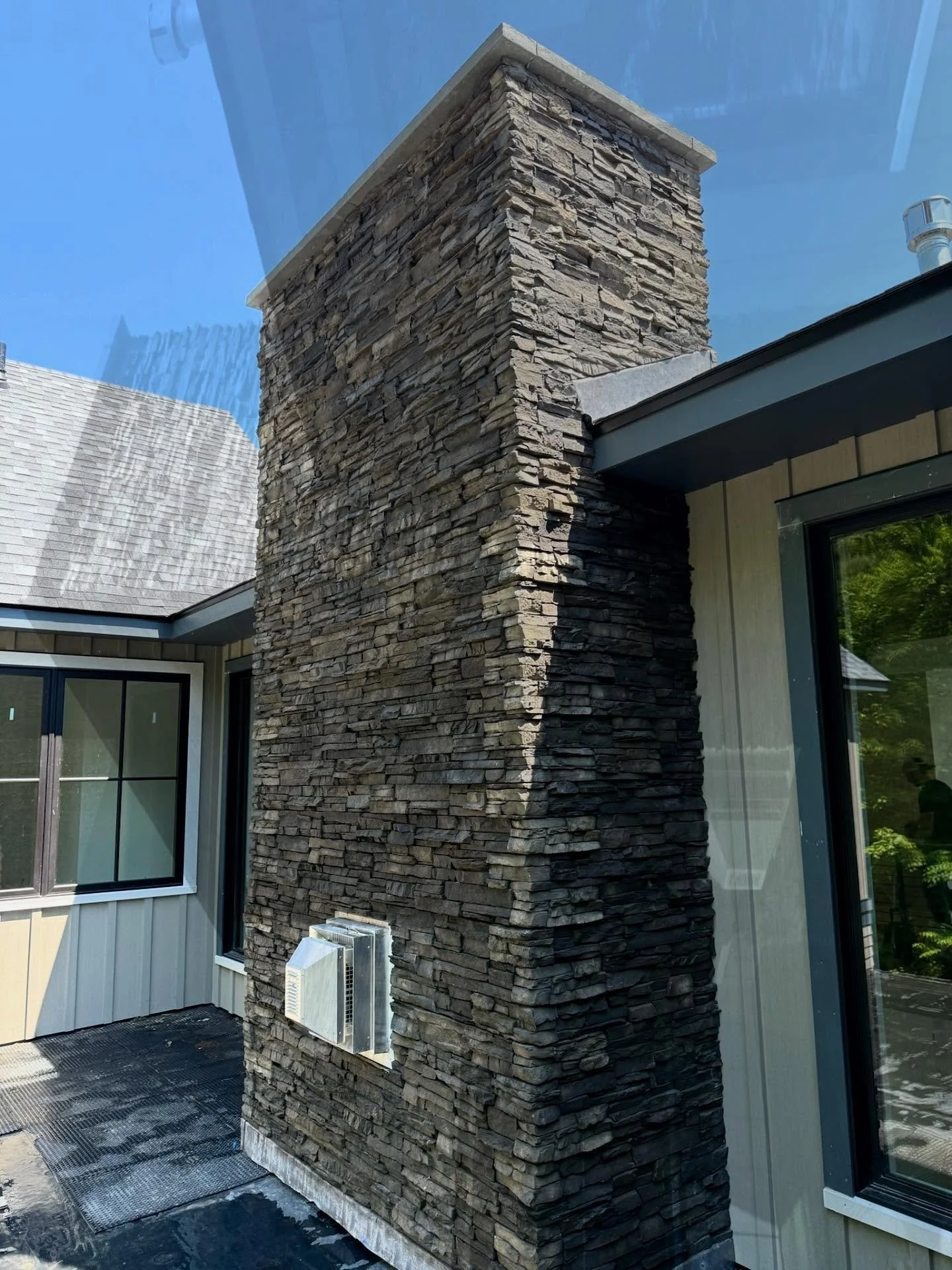 Two fireplaces and a chimney installed with rustic ElDorado stacked stone veneer - natural look with handcrafted detail.