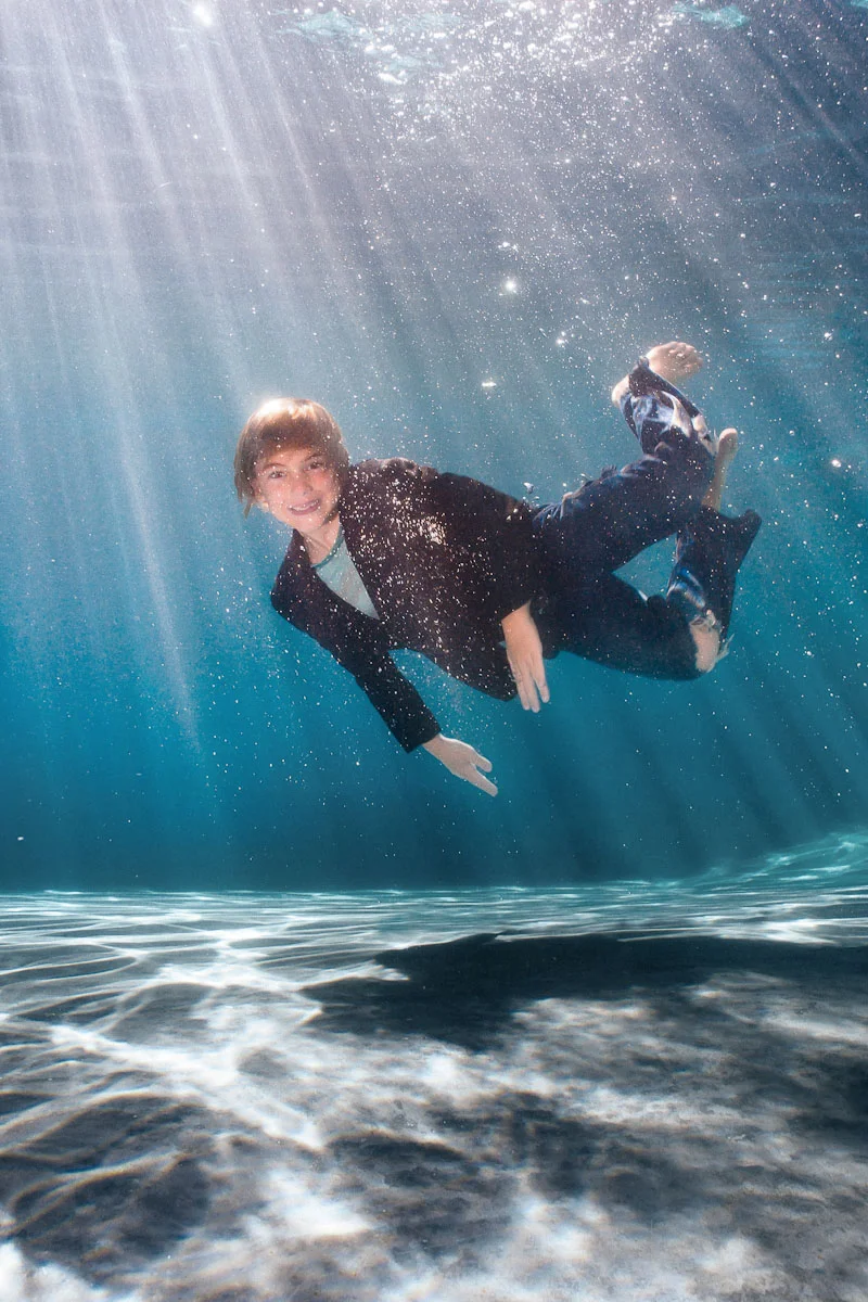 teenage boy enjoying a summer pool photo session
