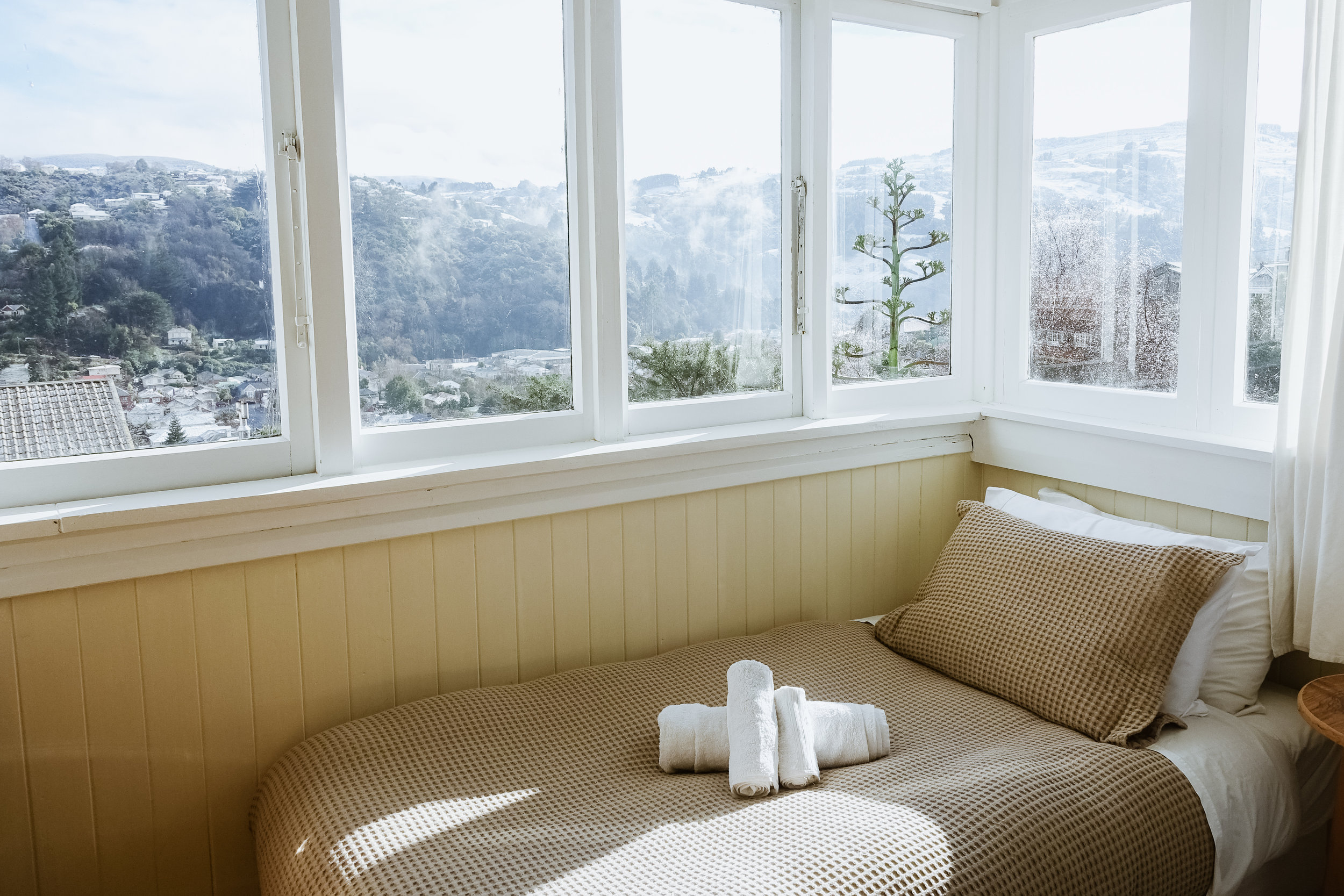 Bed and view from one of the single rooms