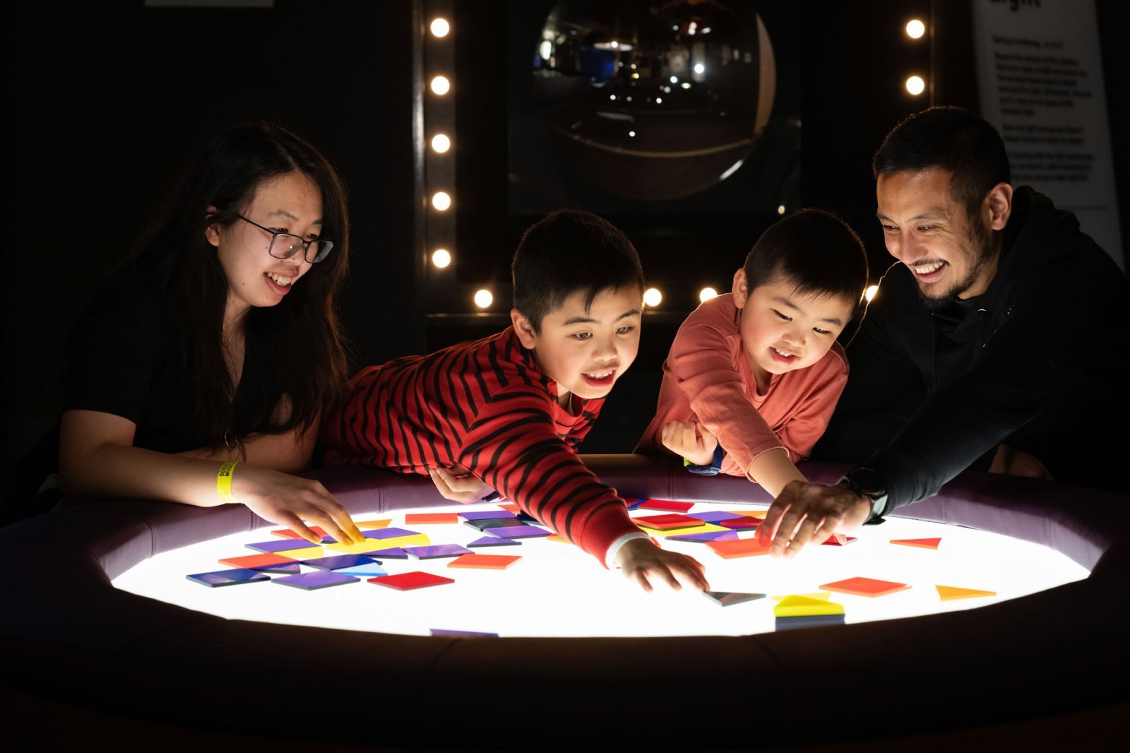 A-family-engaging-with-light-box-exhibit-within-Wonderlab-The-Equinor-Gallery.jpg