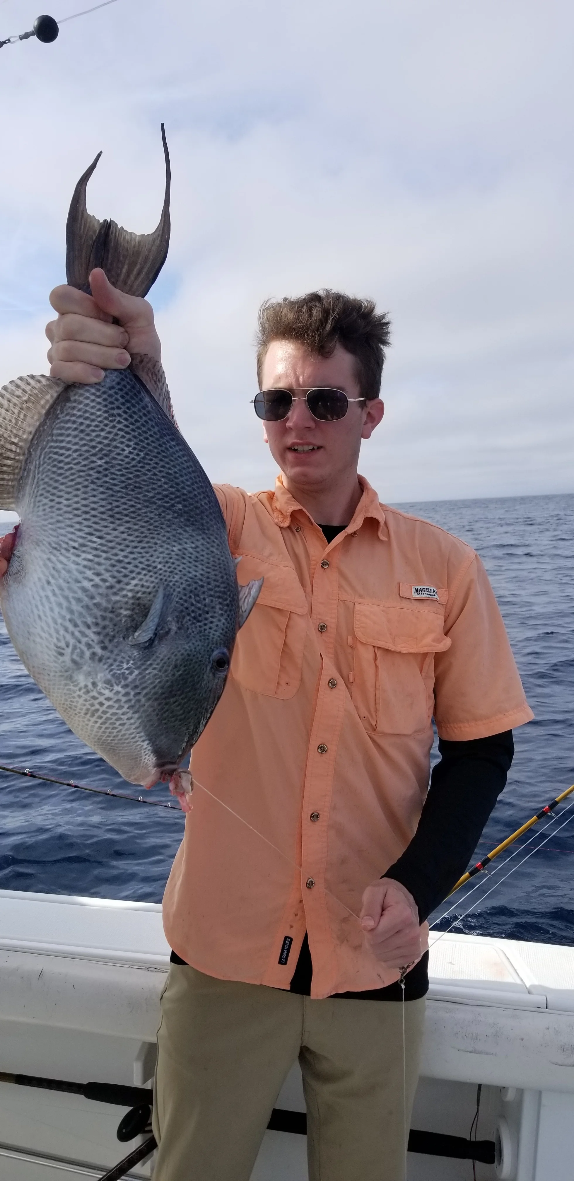 A fisherman holding his catch with Team Buck Rogers