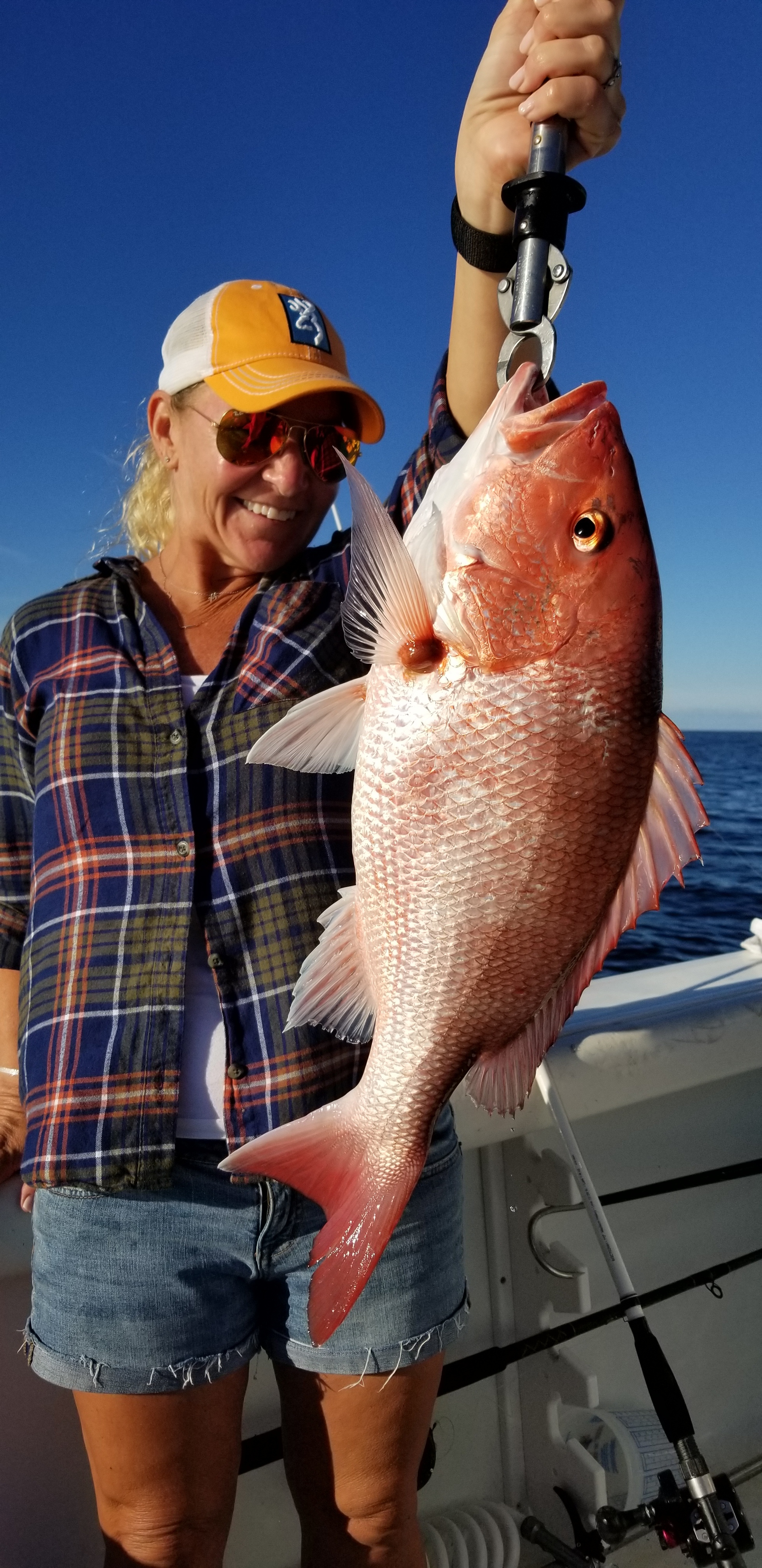 woman holding red snapper catch