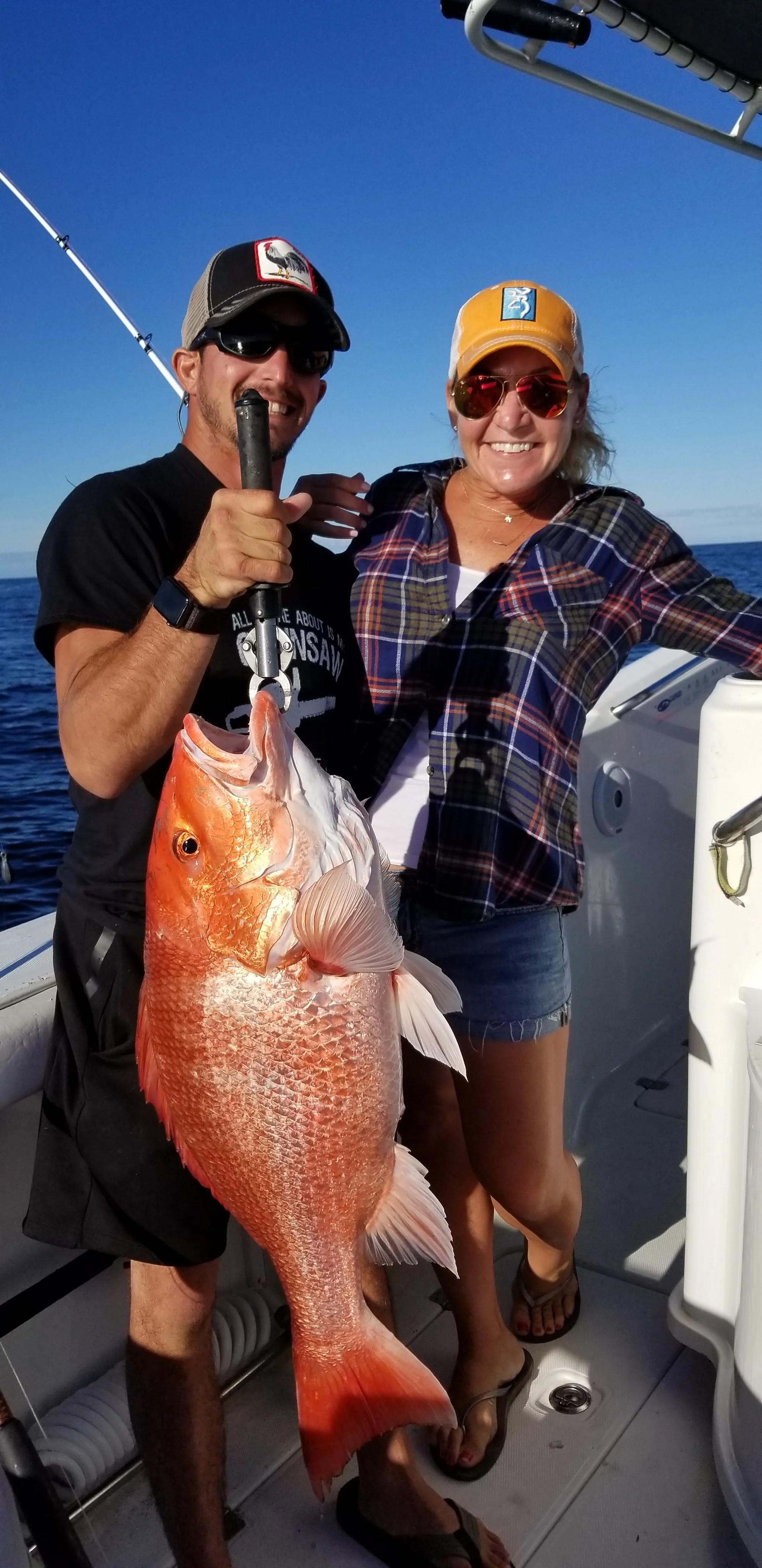 proud couple and their red snapper catch
