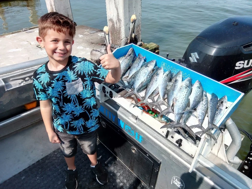 Young Jacksonville fisherman with his Spanish Mackerel catch