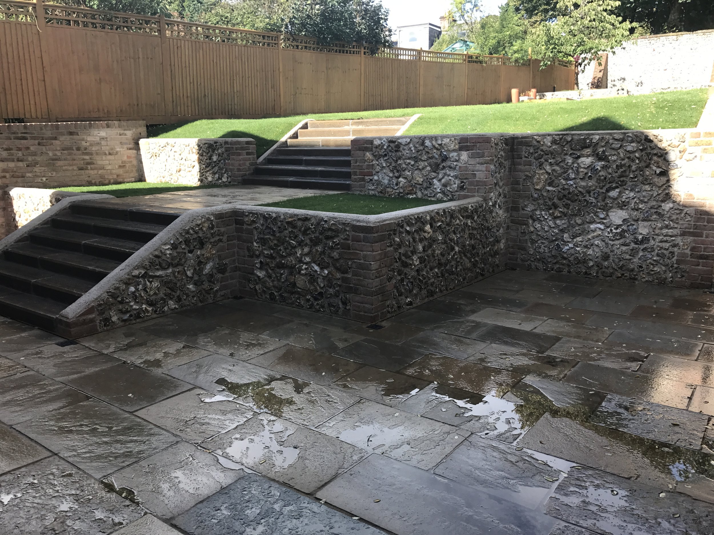 After - reclaimed York stone terrace and flint walled garden