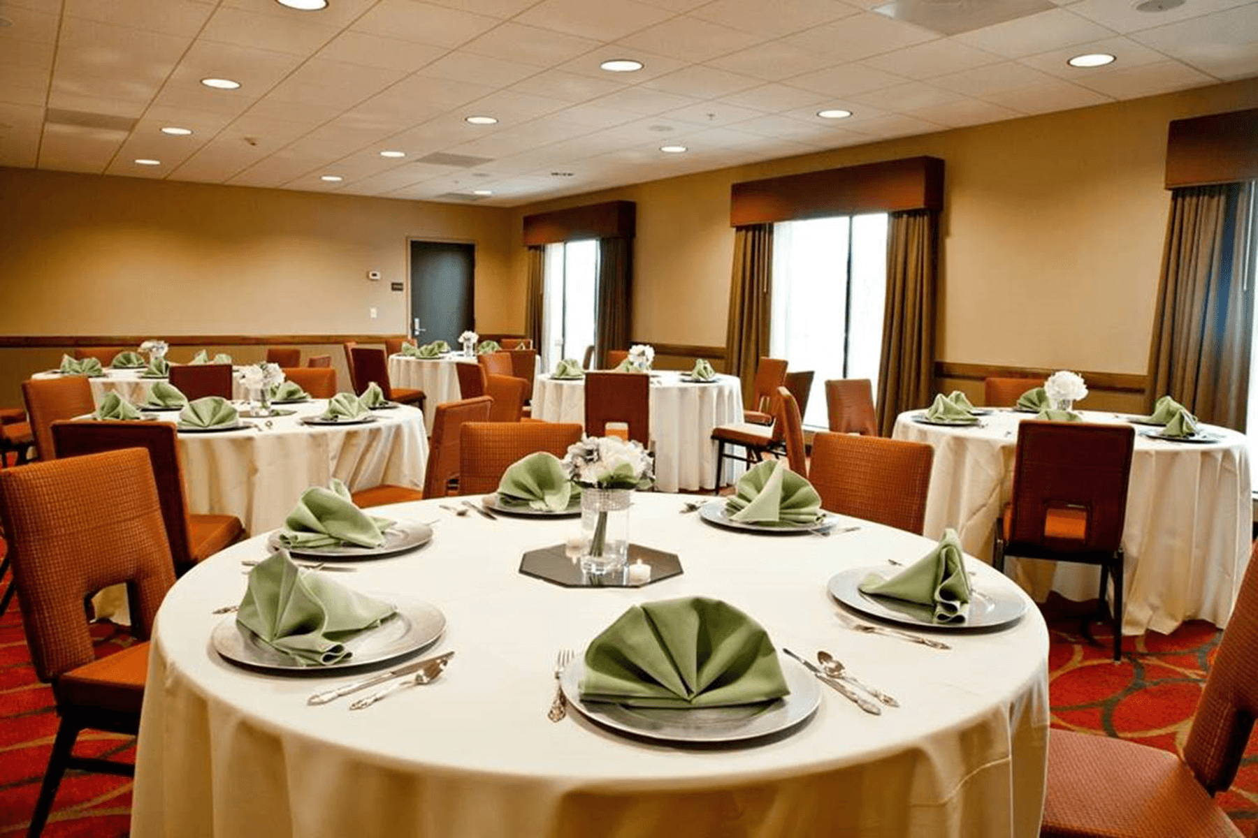  Hampton Inn and Suites Salinas meeting room with set round dining tables 