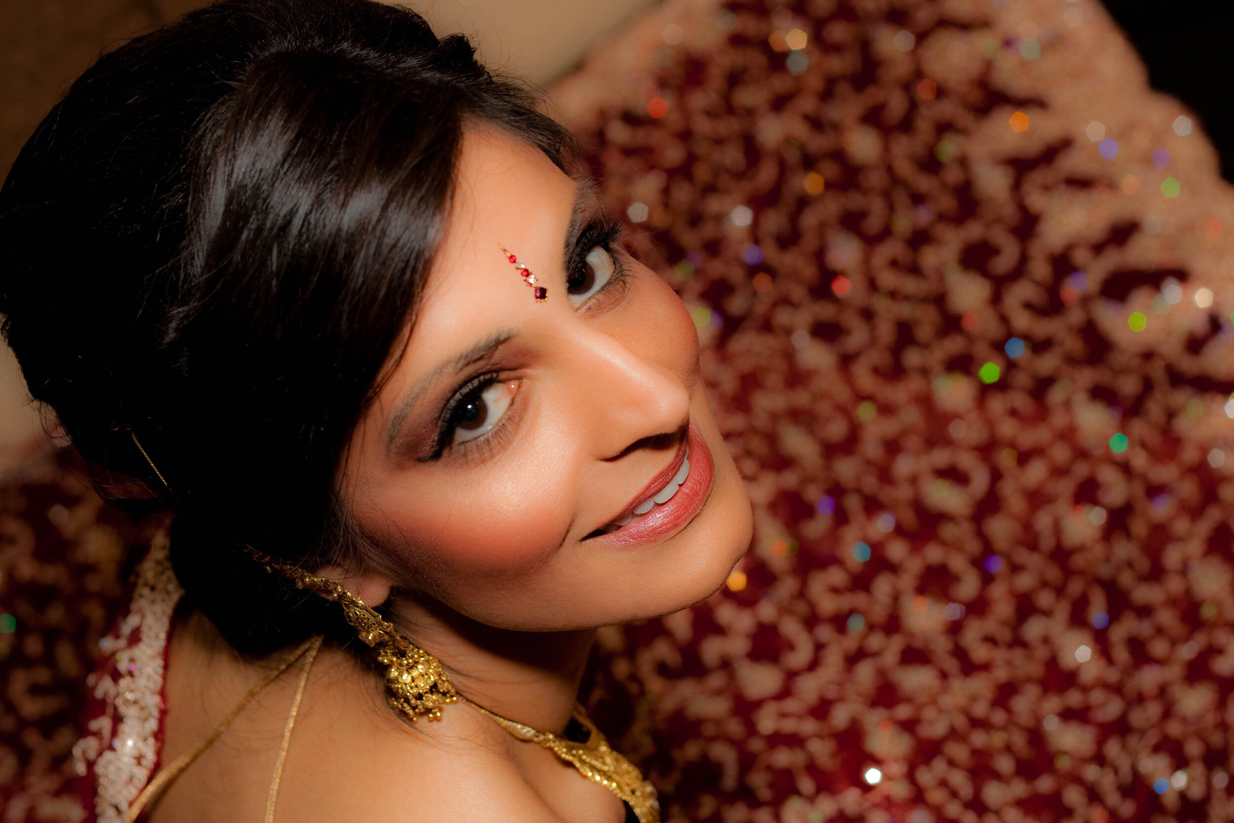  editorial portrait of indian bride wearing traditional red saree 