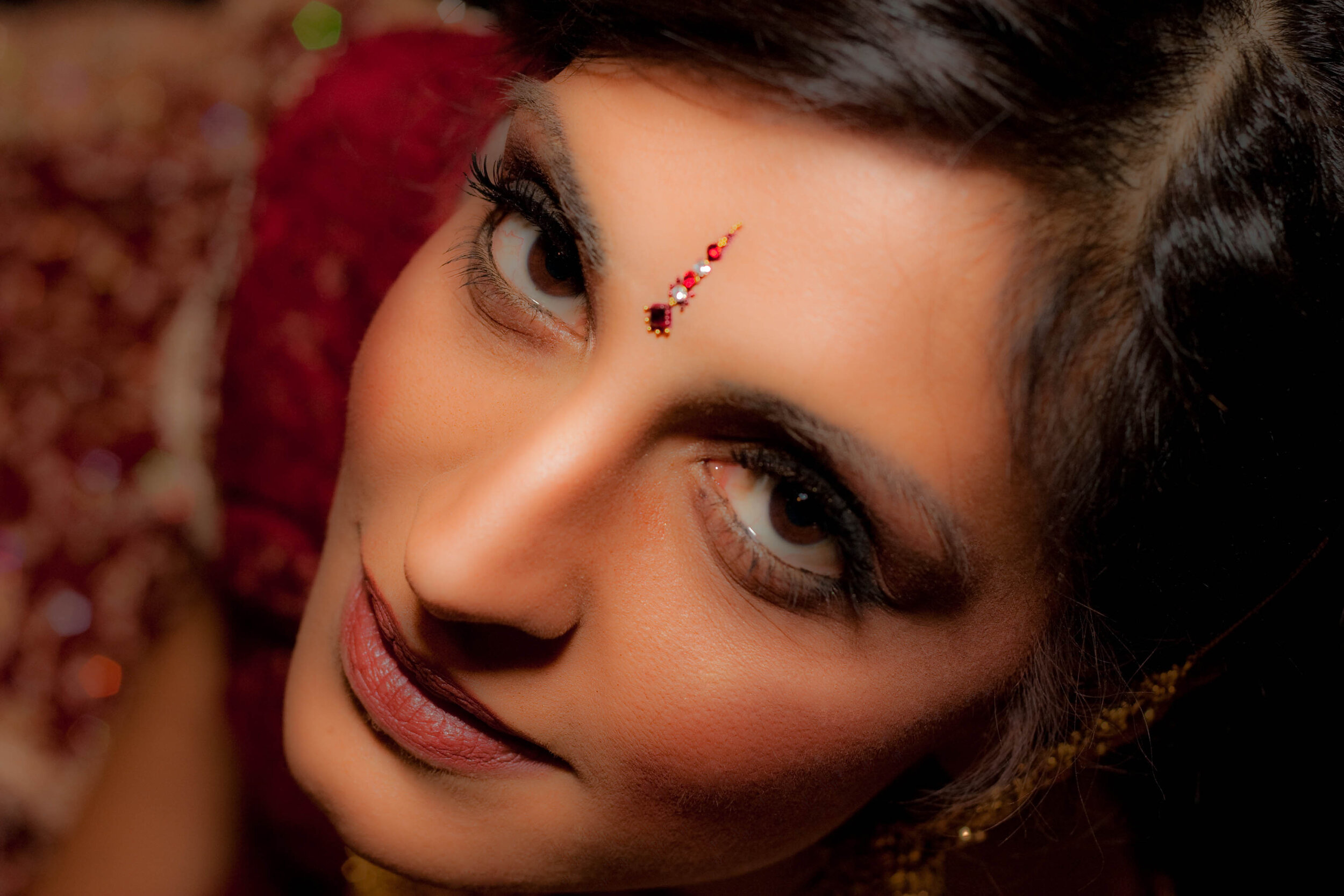  close up of indian bride wearing a red saree 