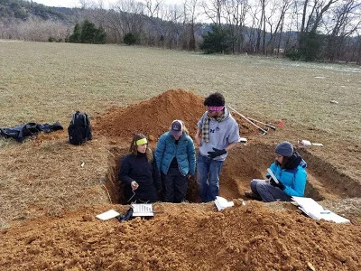 Sam, a grad student from Auburn University, explaining soil horozons to Hannah, Kathleen, and Me.
