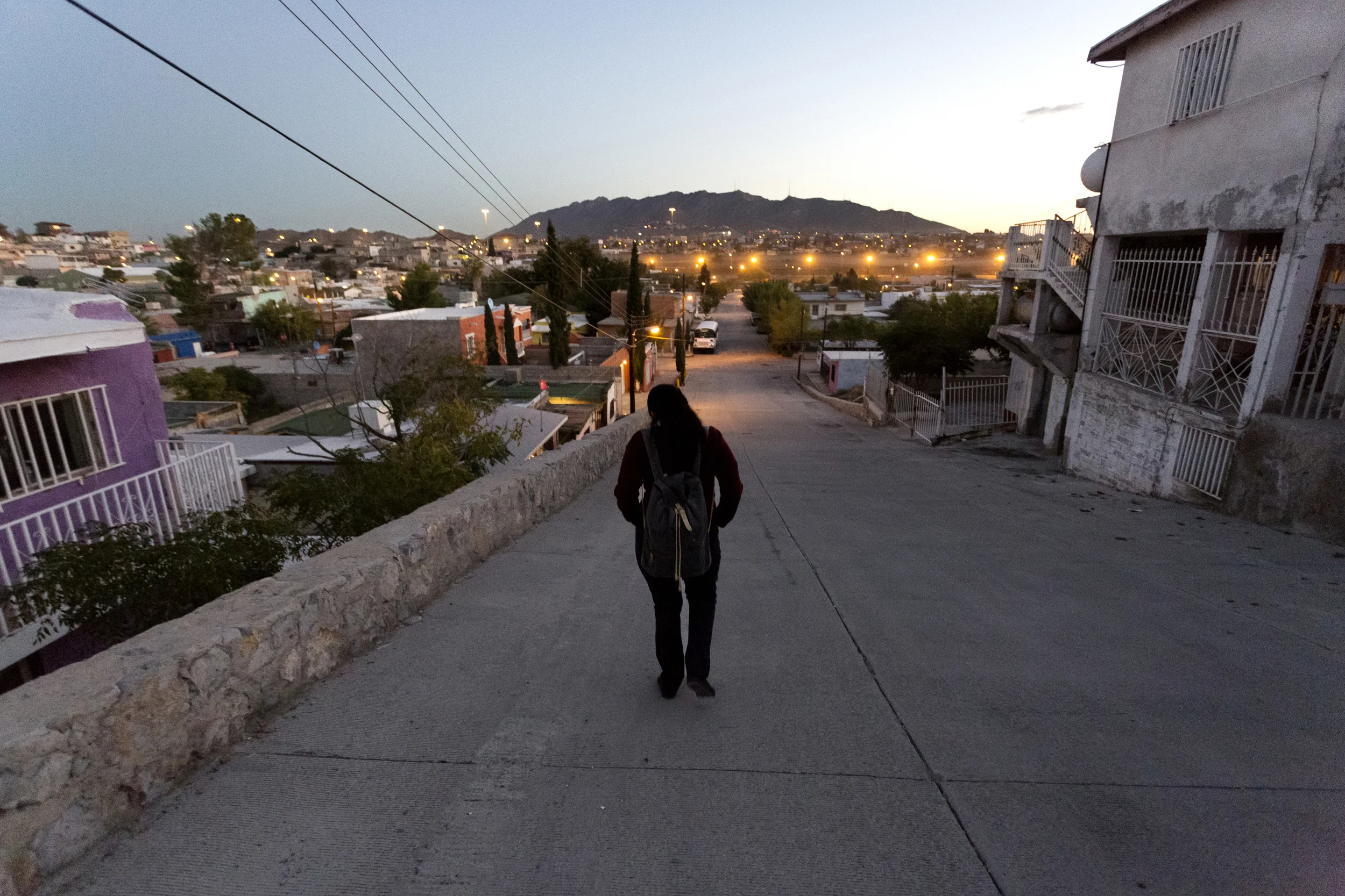 CIUDAD JUAREZ, CHIHUAHUA- Oct. 28, 2015: As the day begins to break, Arlet walks towards her bus stop on Calle Rio Bravo. Miguel Gutierrez Jr. /KUT News.