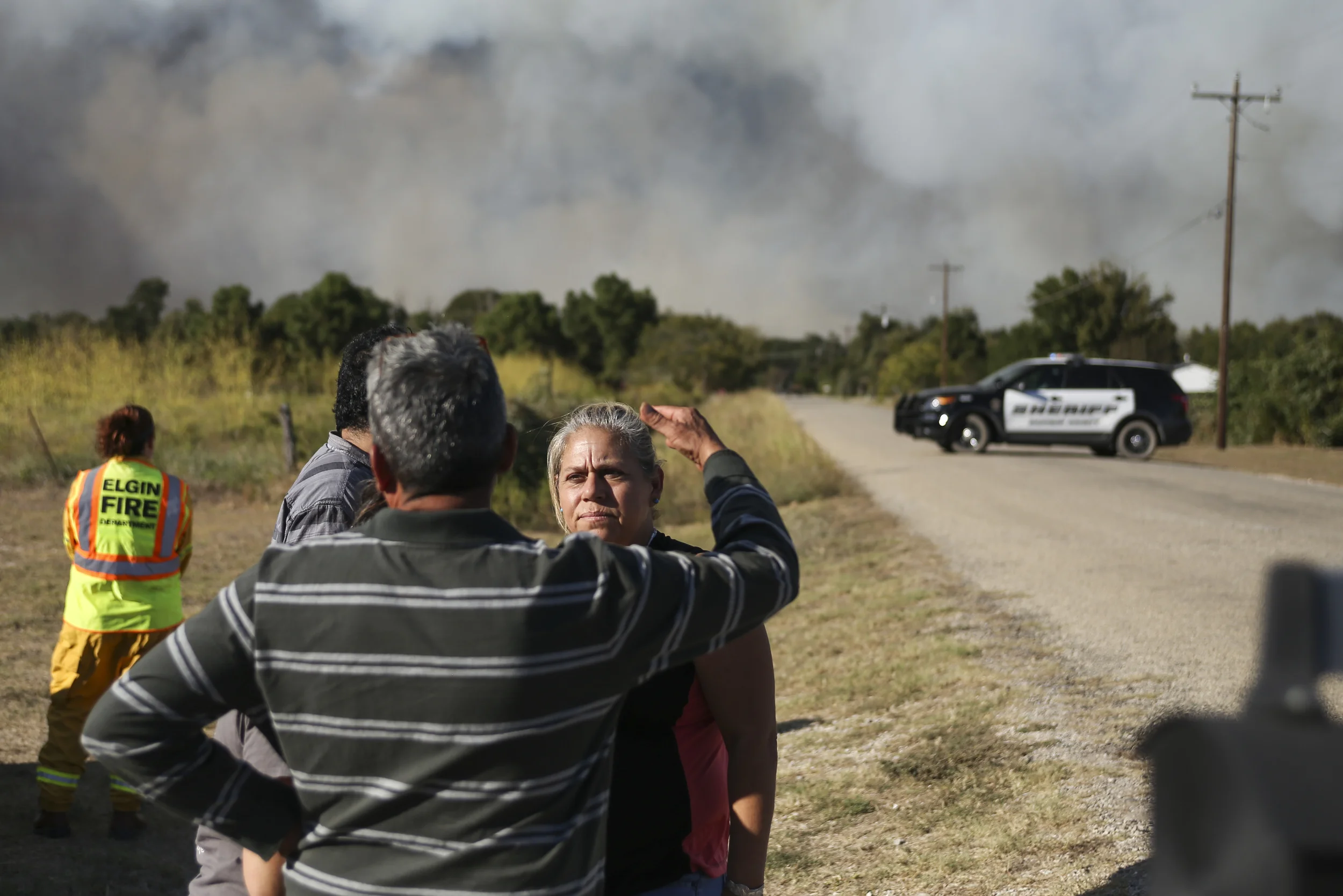 SMITHVILLE, TEXAS - Oct. 14, 2015: Viviana Mora, 47, of Smithville discusses an evacuation plan with her family. Mora survived the 2011 Bastrop fire, and doesn't want to remain in Smithville while the fire burns. Miguel Gutierrez Jr. /KUT News.