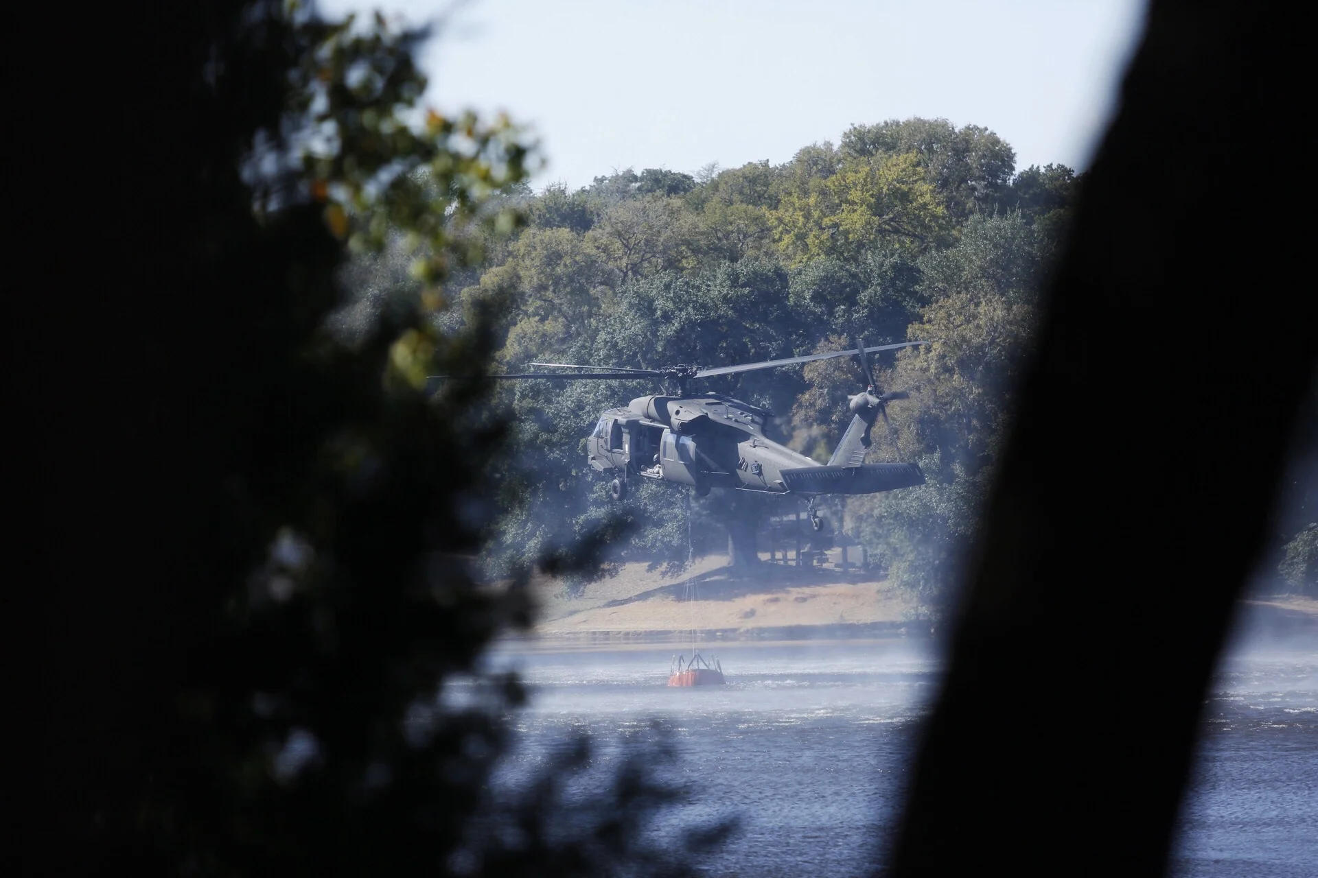 SMITHVILLE, TEXAS - Oct. 15, 2015: A Blackhawk helicopter refills water at the Buescher State Park Lake near Smithville. Miguel Gutierrez Jr. /KUT News.