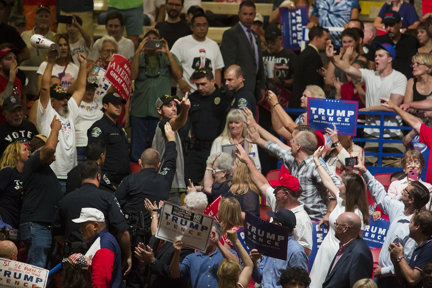 AUSTIN, TEXAS - August 23, 2016: A Trump protester is escorted out of the Travis County Expo Center during the Trump rally. Miguel Gutierrez Jr./KUT News.