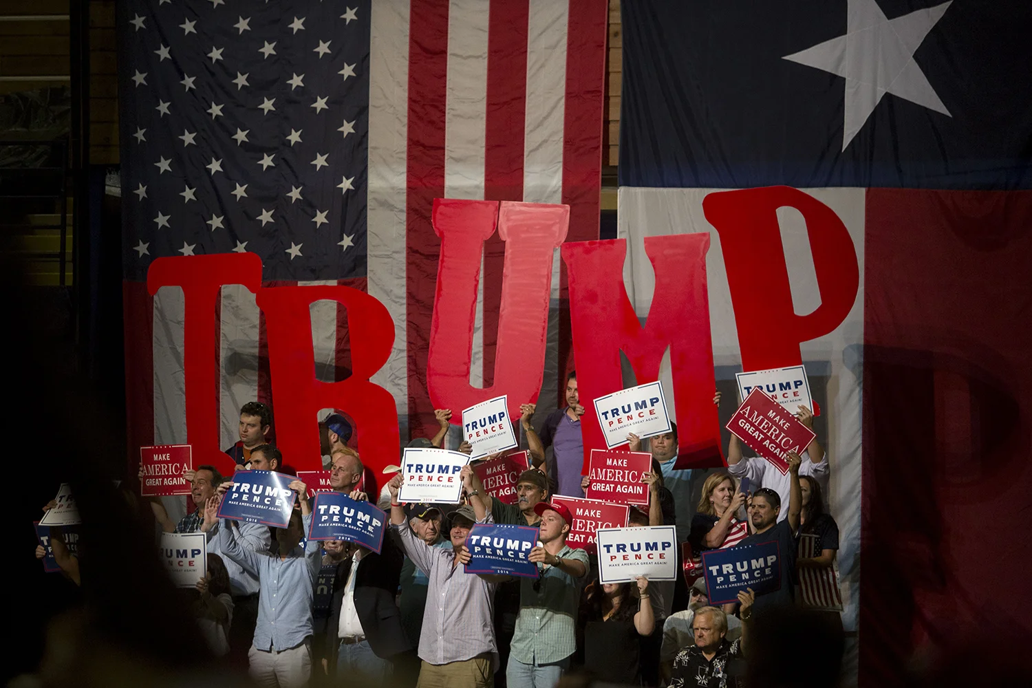 AUSTIN, TEXAS - August 23, 2016: Trump supporters spell out the Presidential Candidtates' name inside the Travis County Expo Center. Miguel Gutierrez Jr./KUT News.