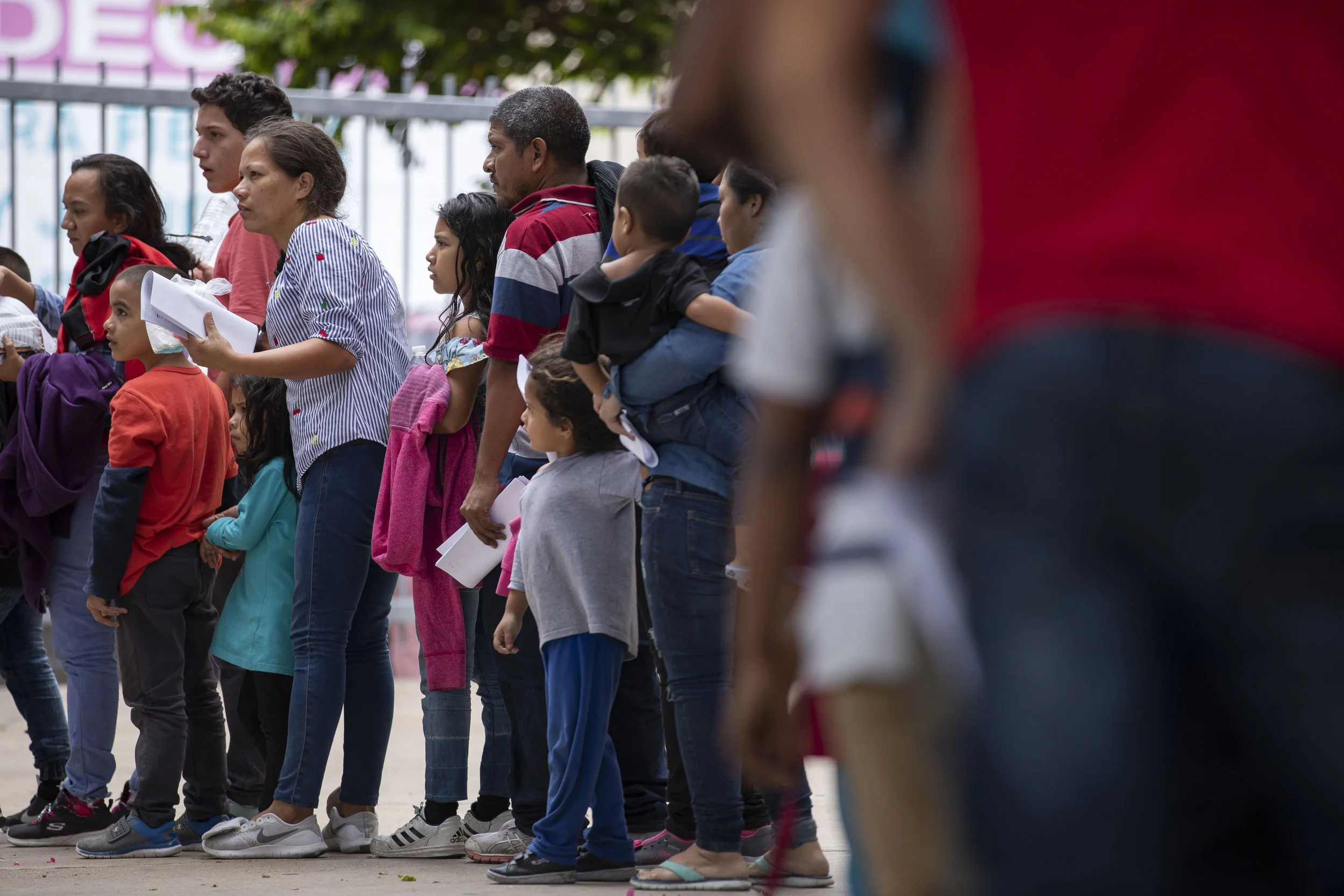 A group of migrants departs the McAllen Central Station after being dropped-off by immigration officials, The group is being ushered by volunteers to the Catholic Charities Humanitarian Respite Center across from the bus station. June 25, 2019.