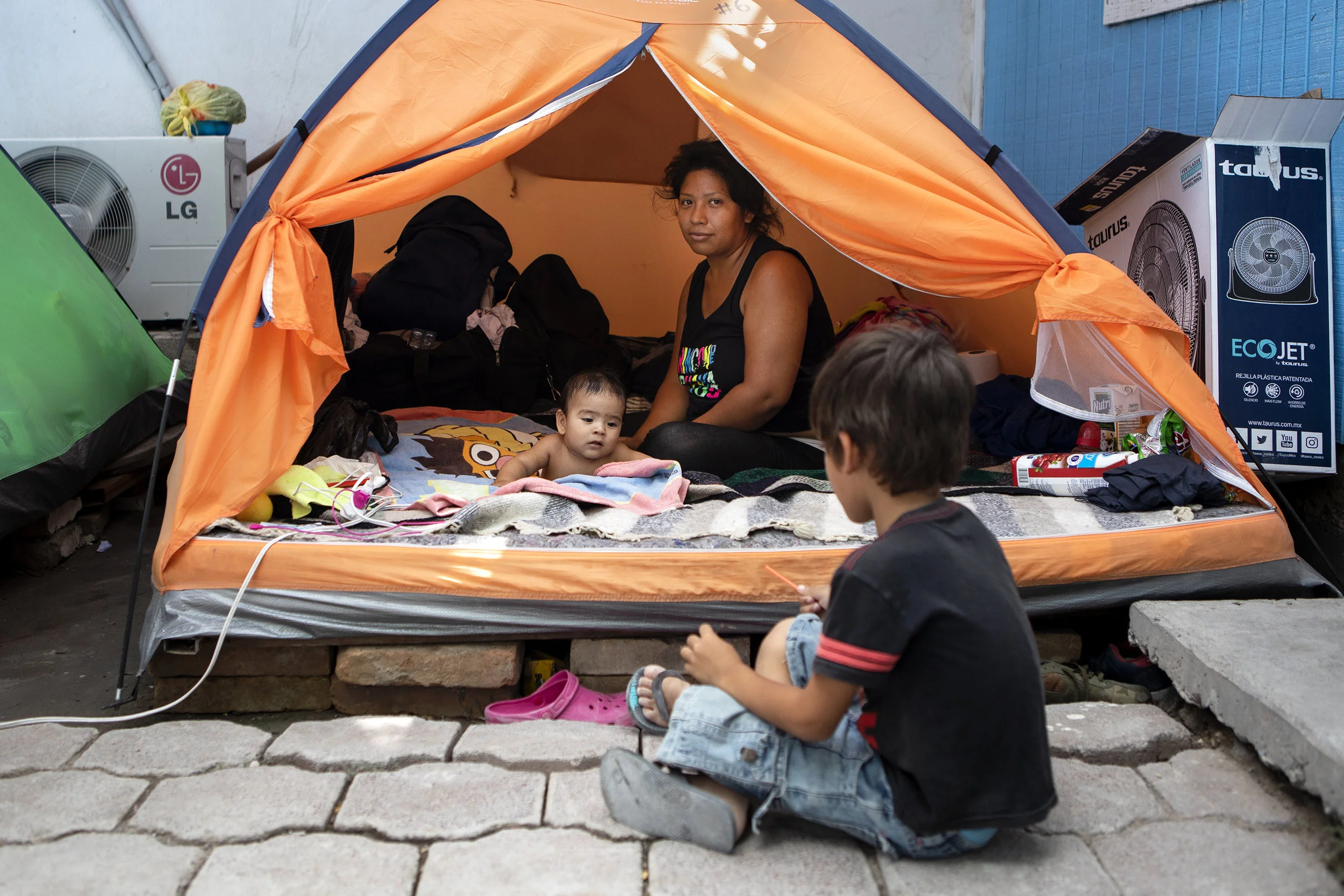 Vanessa Ramos Chavez rests in a tent at Senda de Vida migrant shelter in Reynosa, Tamaulipas. She arrived to the shelter from El Salvador with her baby, Anderson Josue. The pair have been at the shelter for over a month. June 29, 2019.