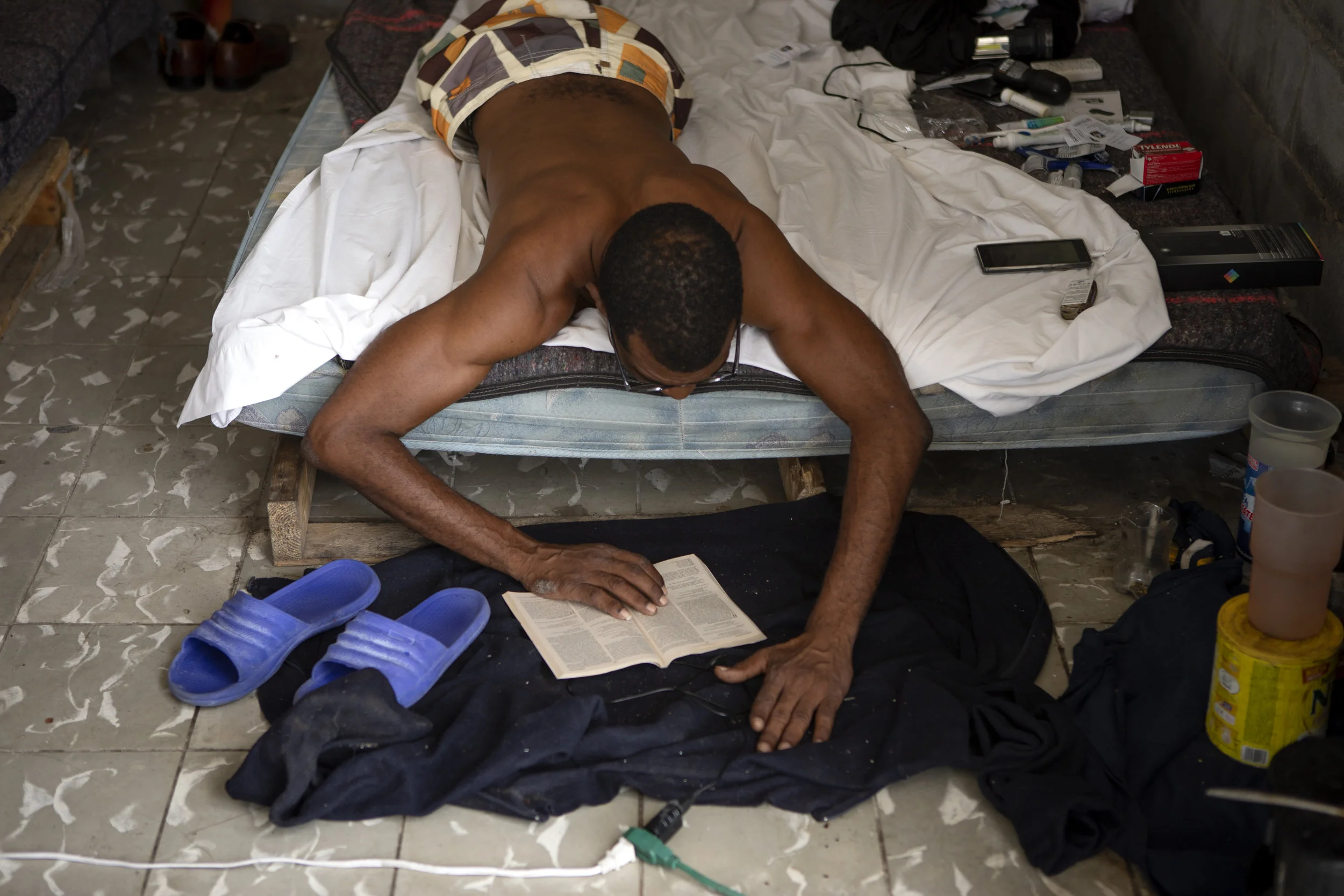 A Cuban migrant reads a book while at the migrant shelter in Nuevo Laredo, Tamaulipas on July 22, 2019.