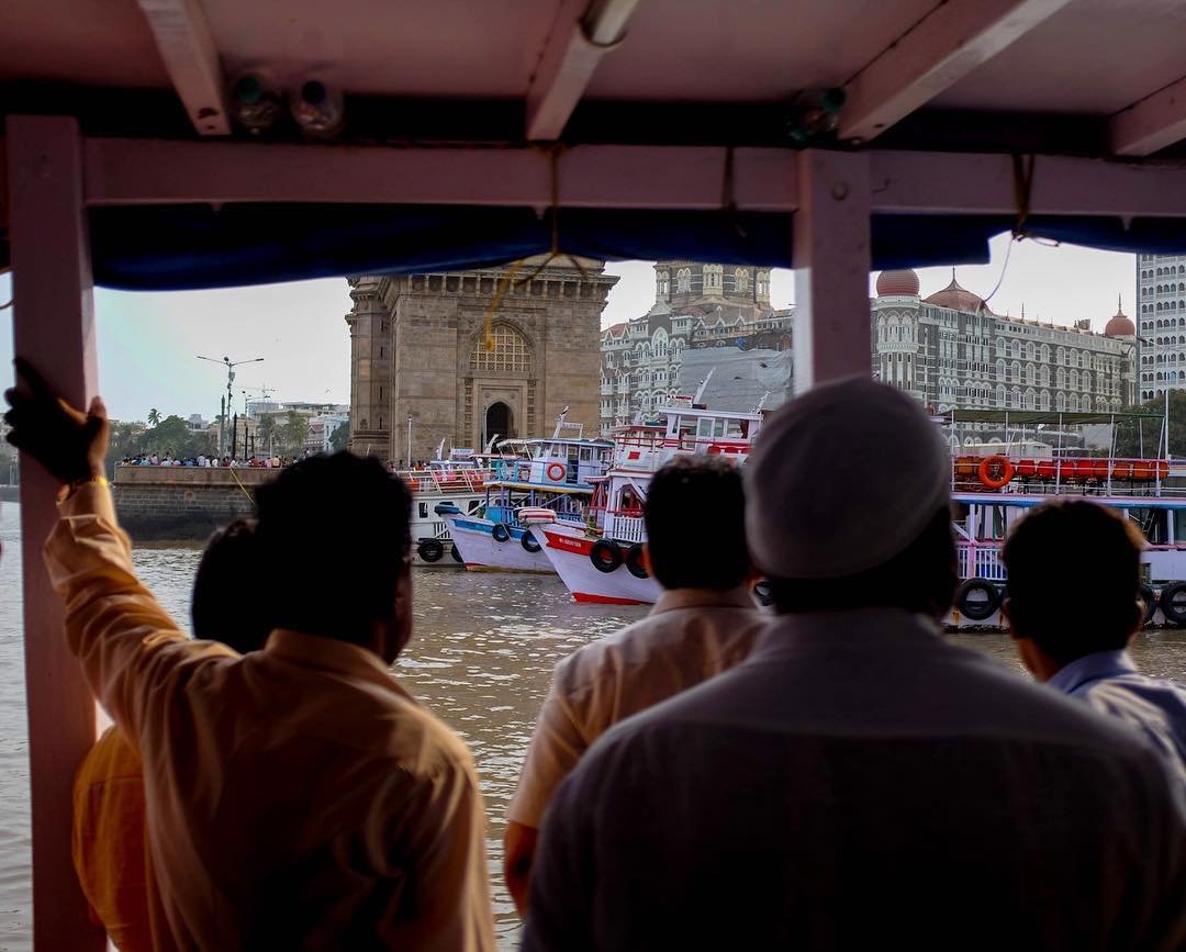 Just a bunch of guys on a boat looking at other boats.