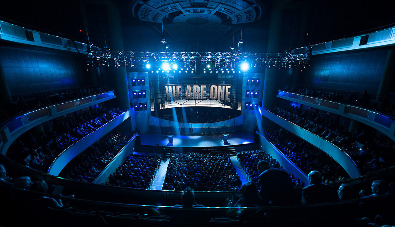 Large stadium filled with people and a stage