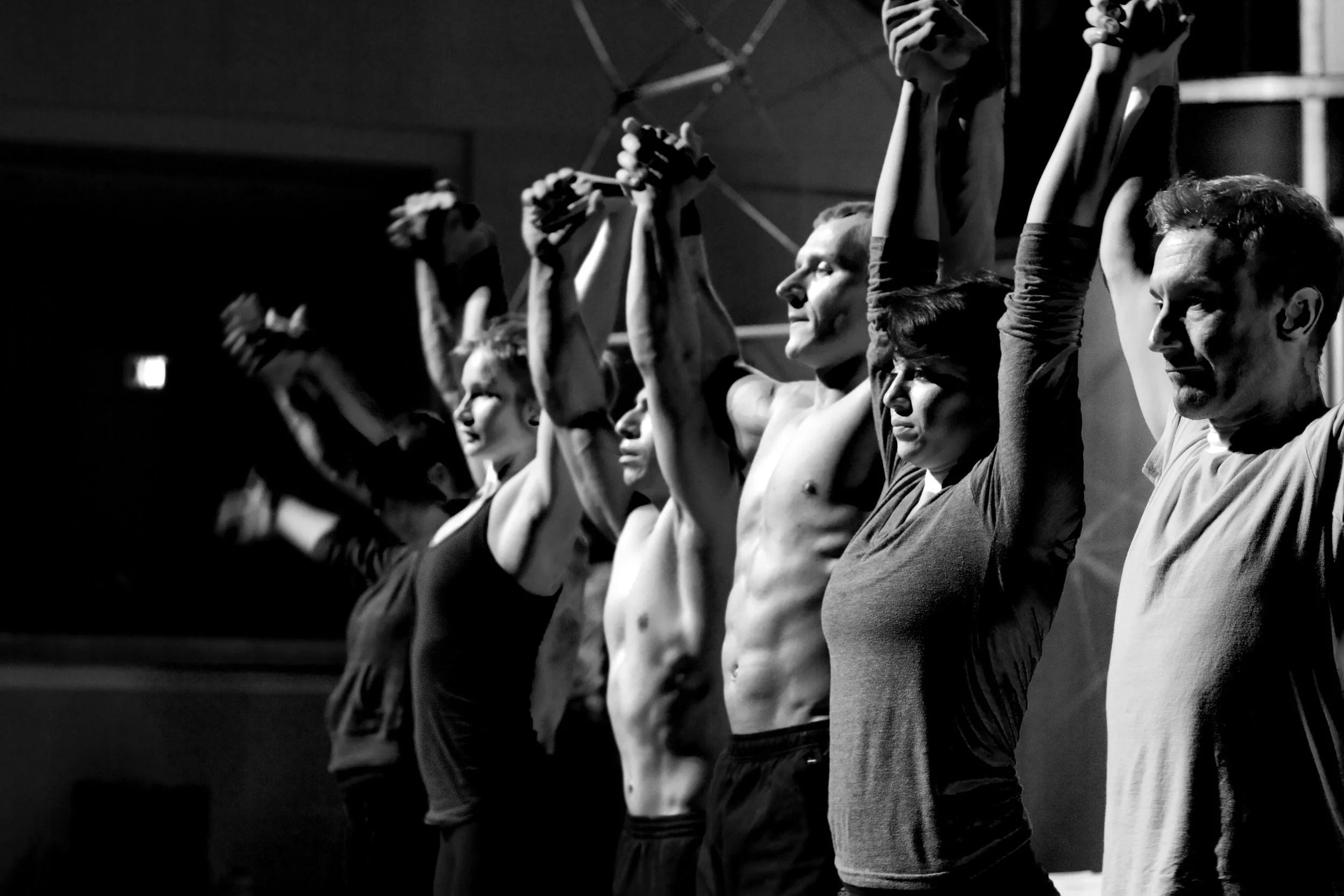 A group of people holding hands above their heads