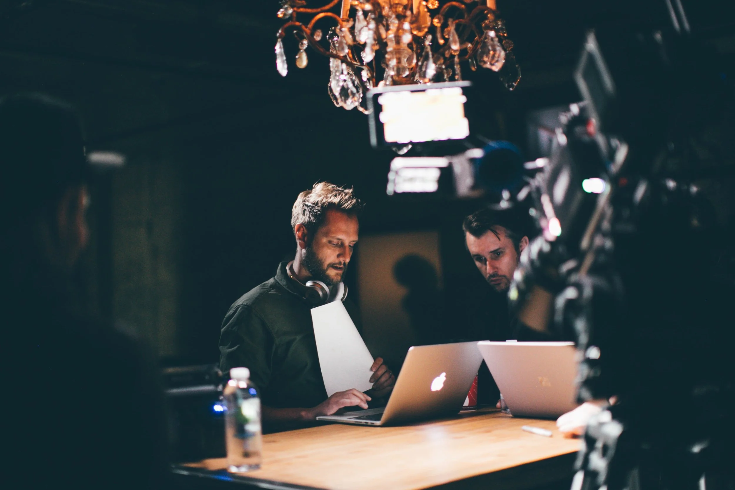 Two middle-aged men looking at a laptop computer