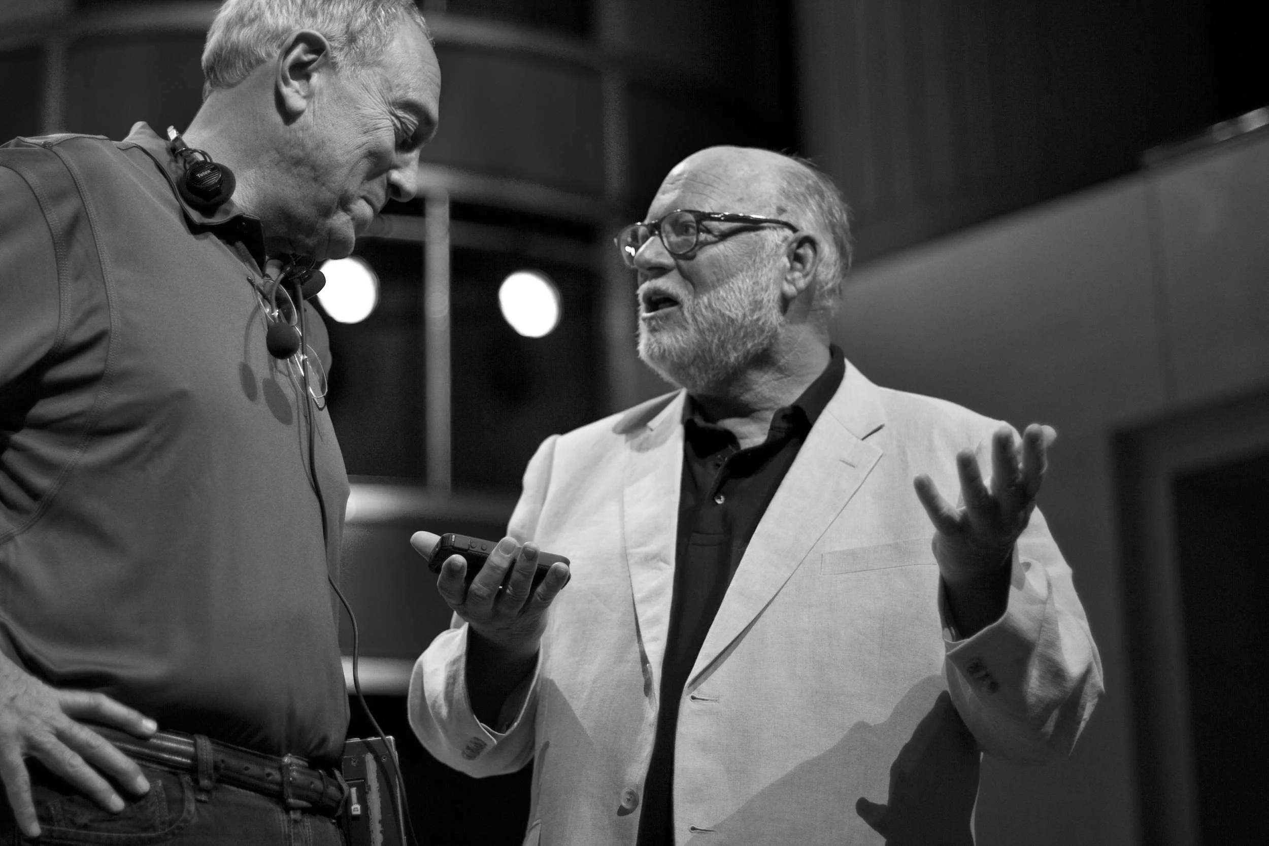 two men talking on stage