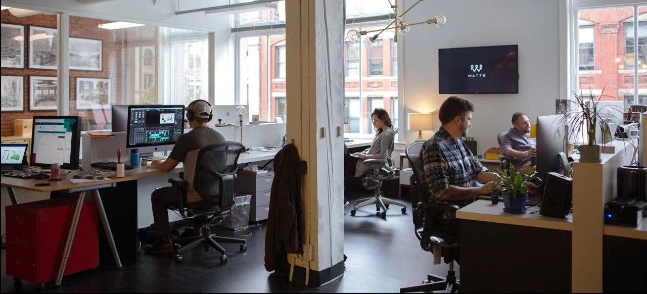 four people in open space video production office