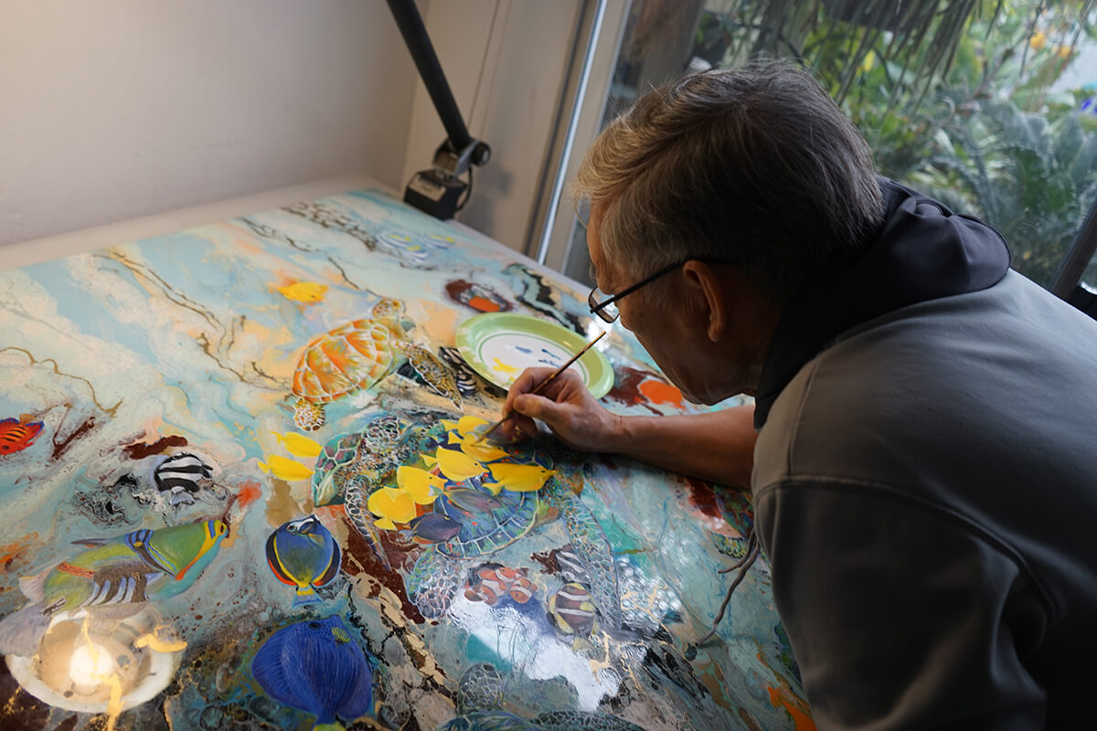 Giam painting “Free Swimmers”