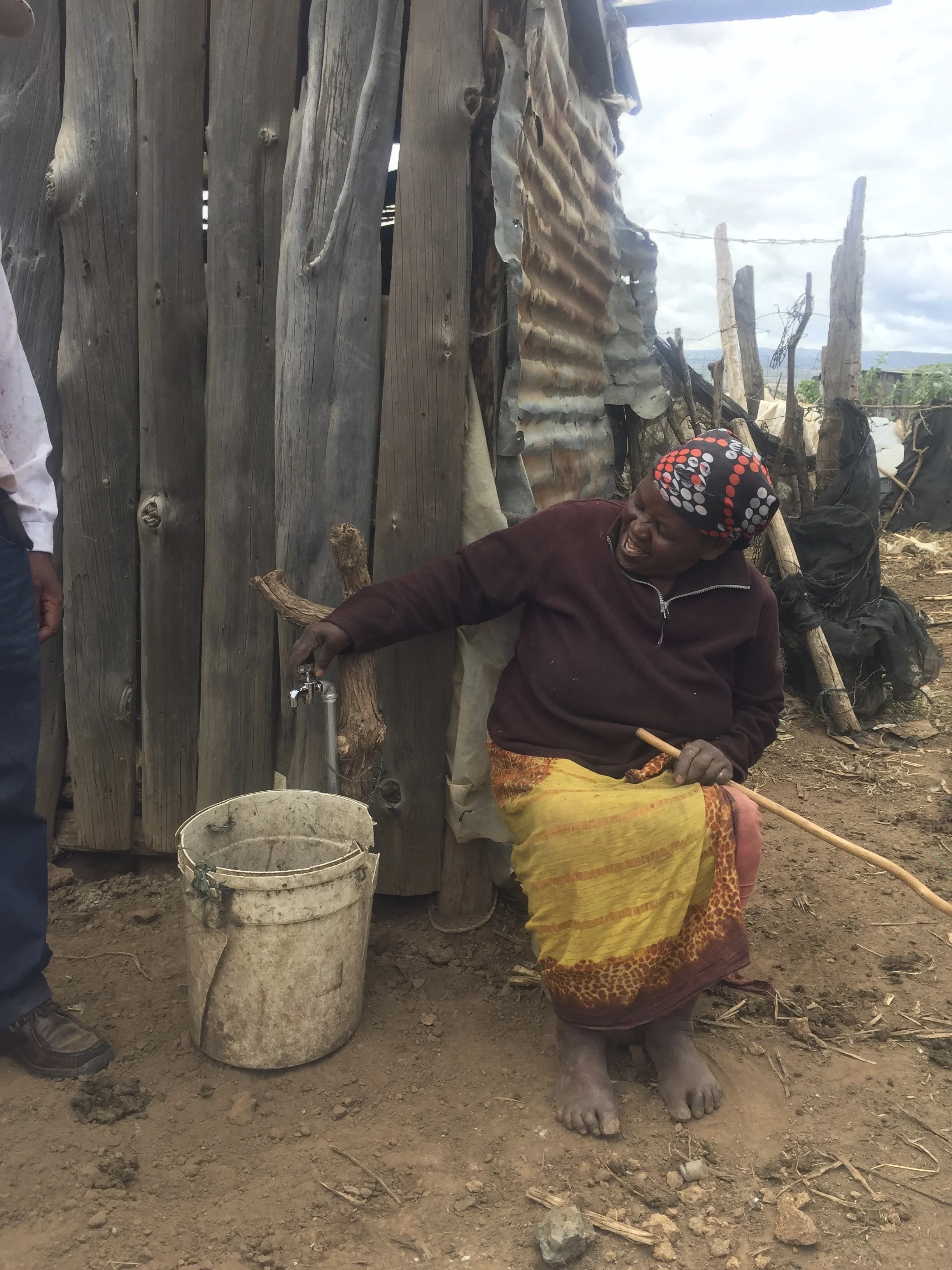Grandmother is excited to have her own water tap