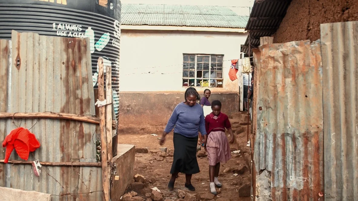 The entry to Adventure Pride School prior to being bulldozed, with their tank to collect water