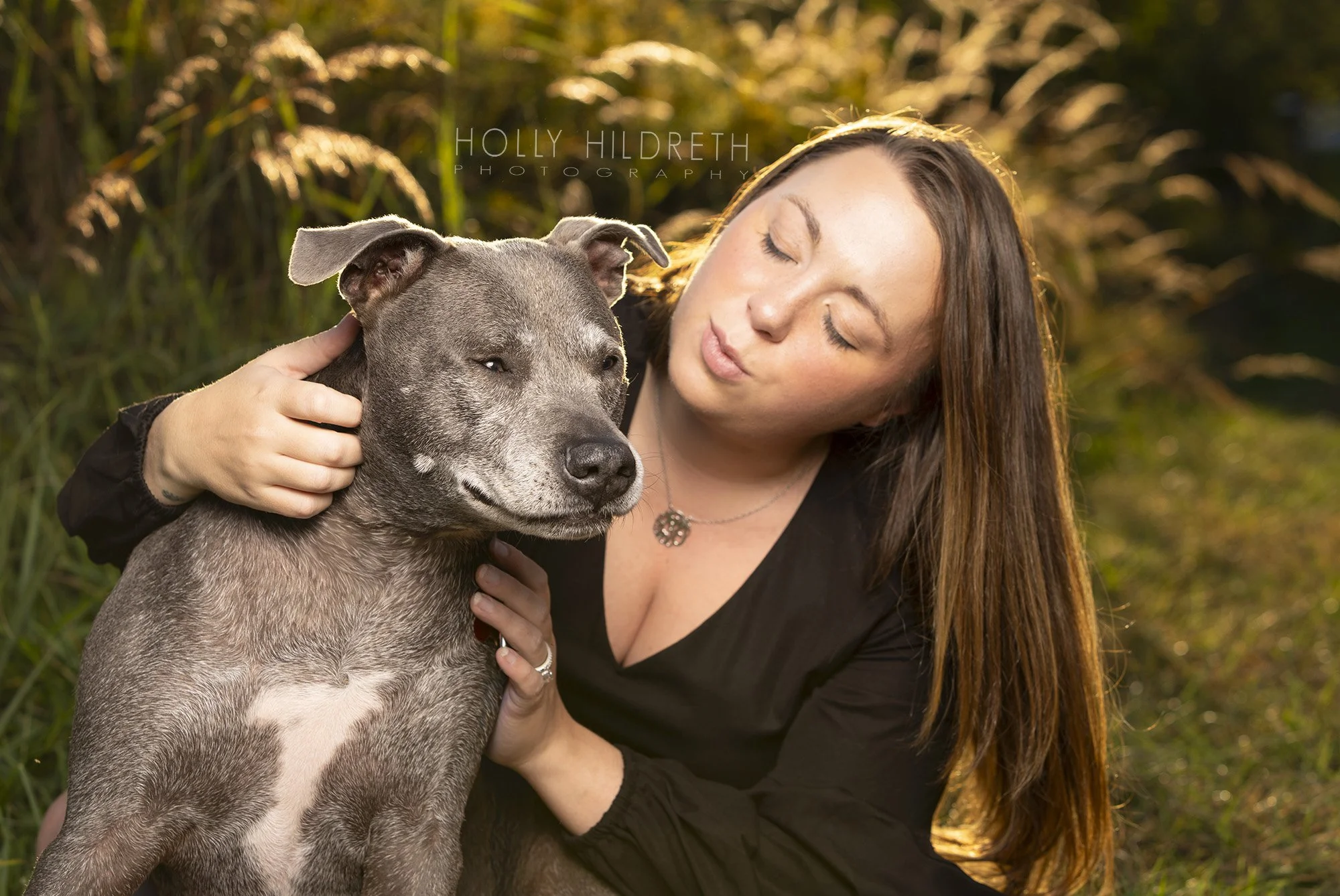 A candid moment of a dog and owner posing during a pet photography session in the fall in Alexandria, Ohio