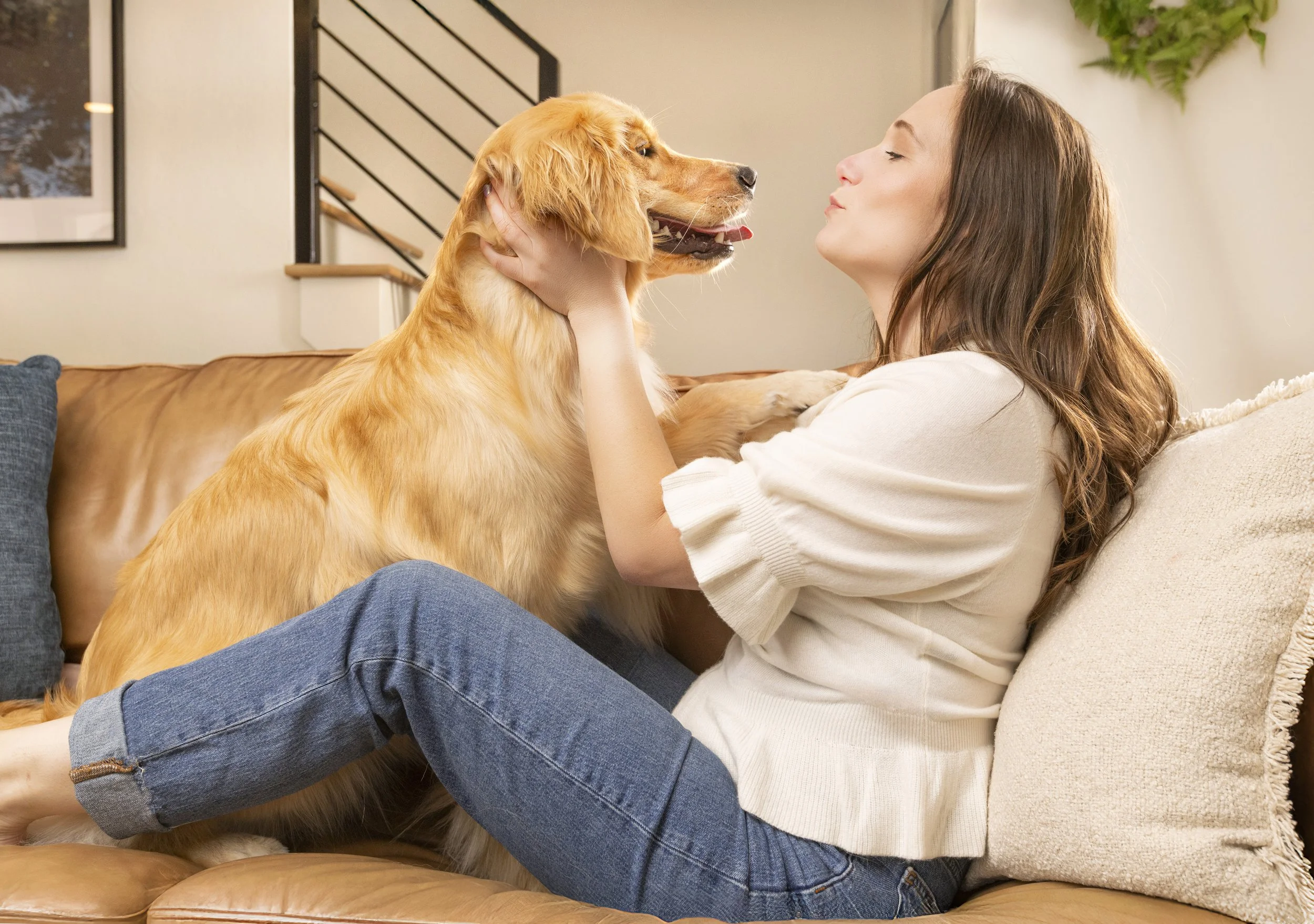 Commercial Pet Photography of a woman and dog on the couch in a nice home, as photographed by commercial animal photographer Holly Hildreth in Columbus, Ohio