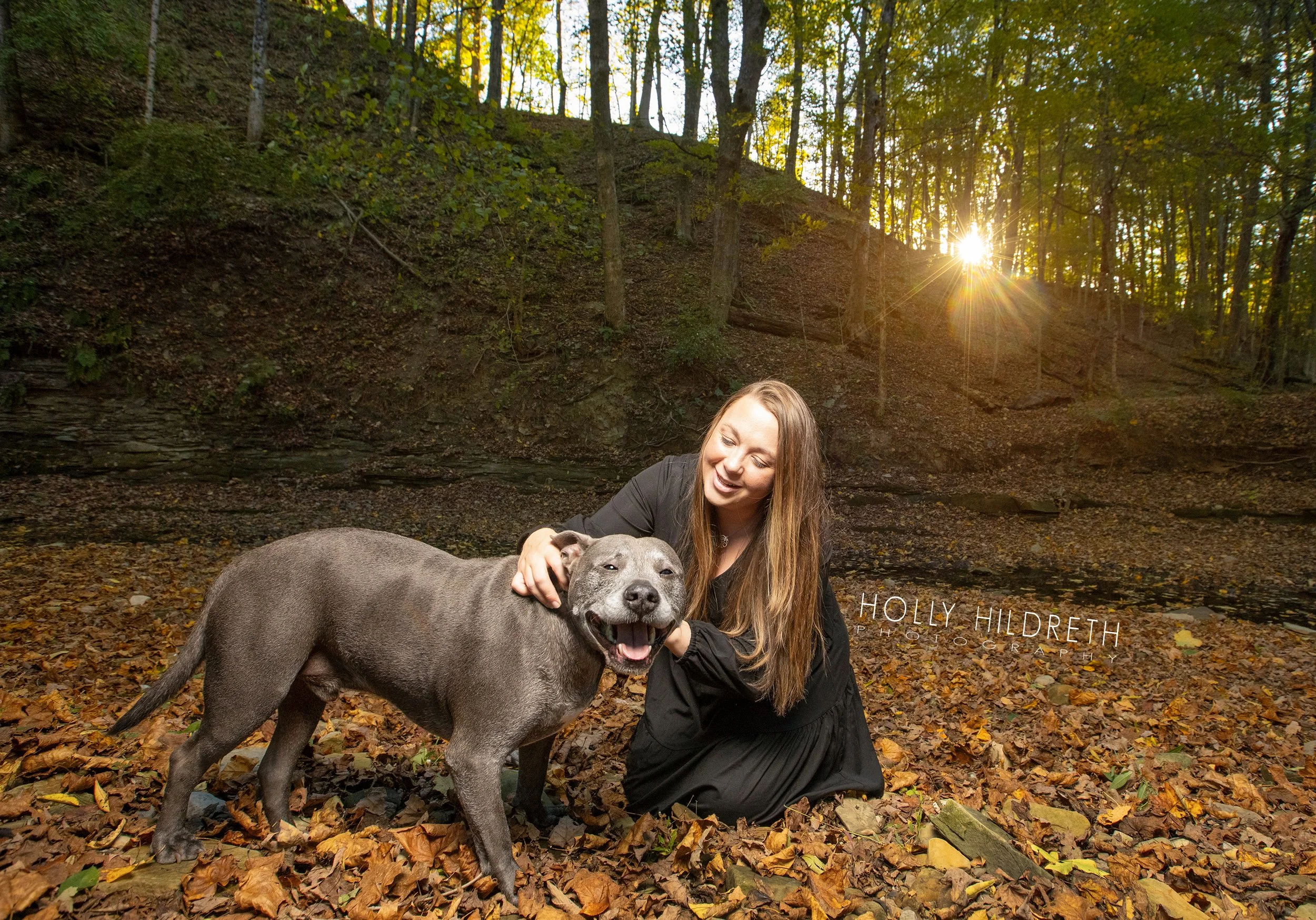 A woman and her dog pose with a smile during their pet and family photo shoot in Columbus, Ohio