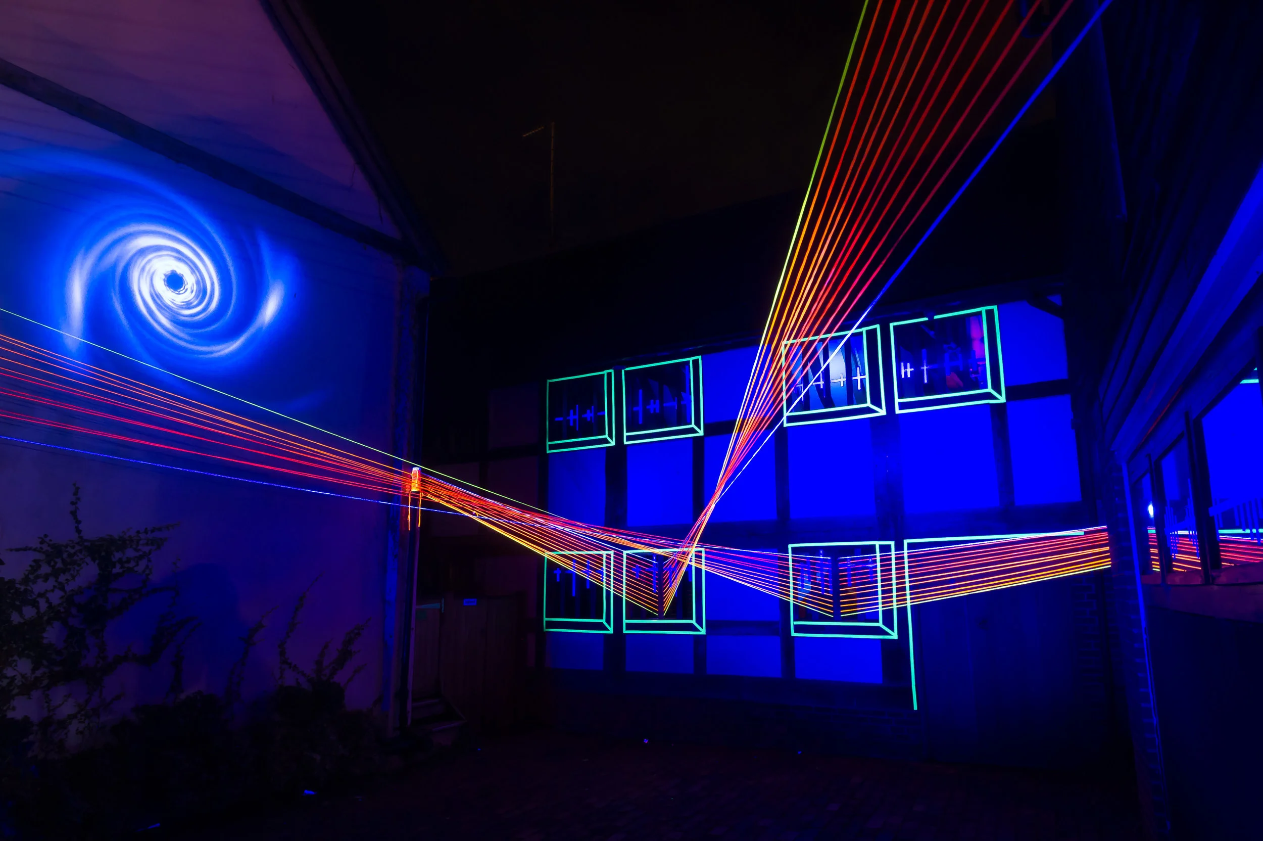 Studio Fractal's installation North Court & Malcom Rose’s workshop combining light, UV, video projection, colour, craft and sound.