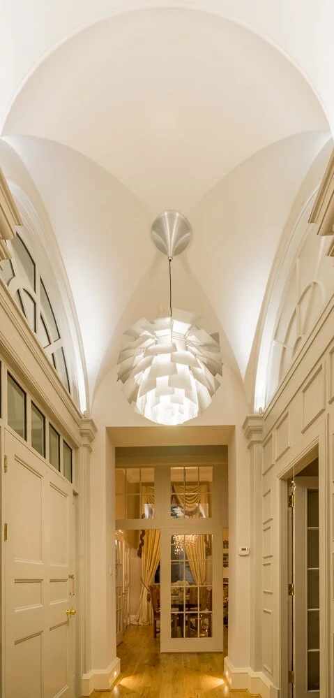  We aimed to emphasise the grandeur of the original features of our clients Georgian apartment situated on the Royal Mile in Edinburgh. The apartment has swooping 4m high ceilings and a stunning barrel vaulted entrance, which we highlighted softly wi