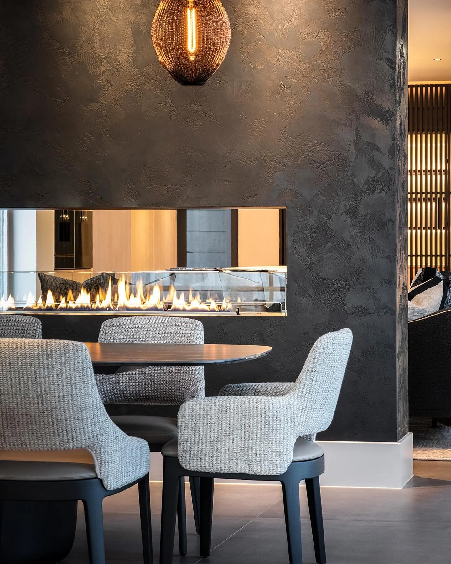 Views through to the kitchen from the dining space at our residential lighting project in South Yorkshire. The stunning textured finish of the fireplace is highlighted with downlights creating a focal point in the space.

Lighting design @susanlakeli
