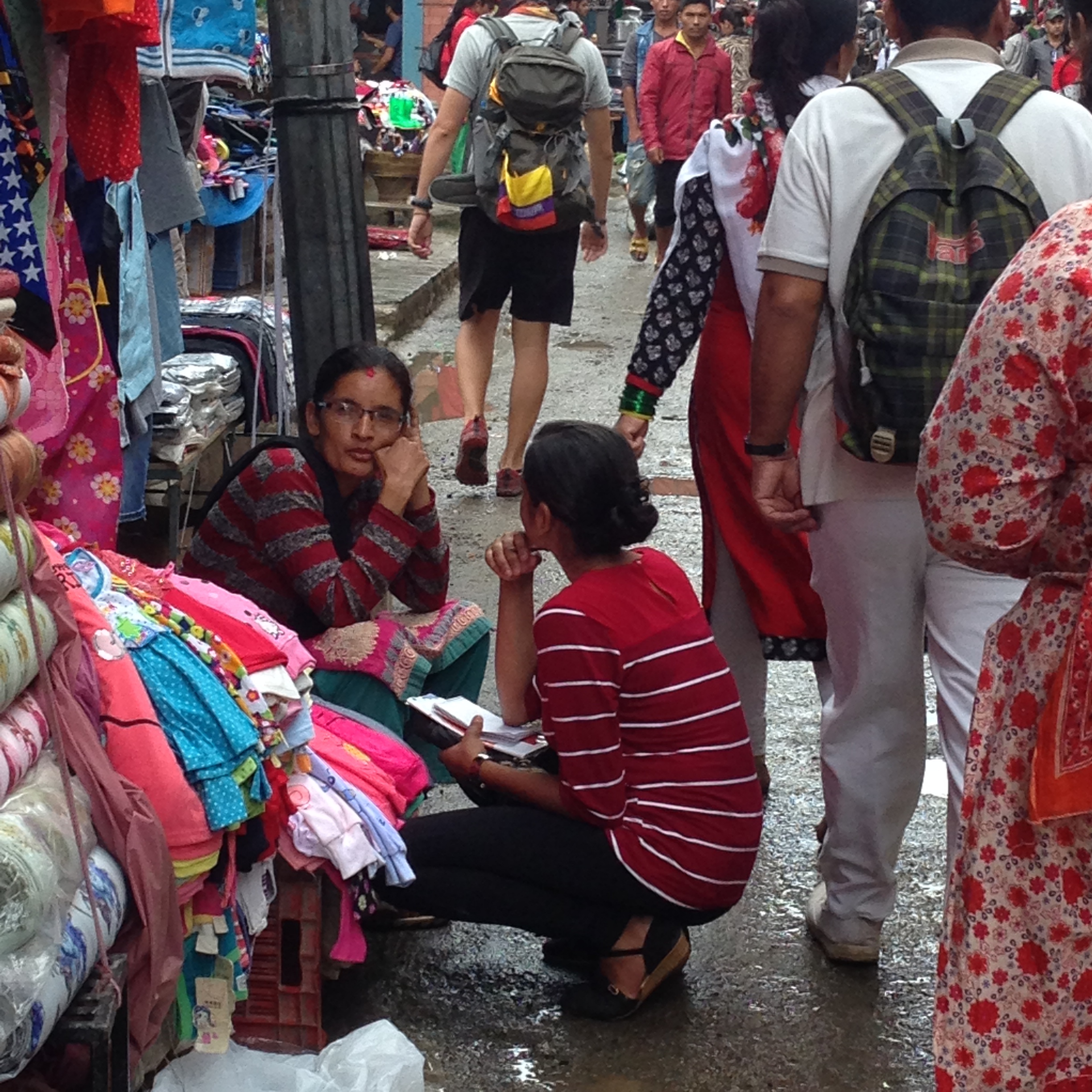 Youth talking with a clothes vendor