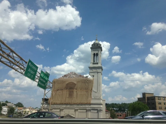 Driving down 290, one can see the crumbling facade of Mt. Carmel Church. Known as "Our Lady of the Highway", this church is showing the impact of 40 plus years of highway fumes on its structure. The church is a good example of the "slow-kill" of urban renewal.