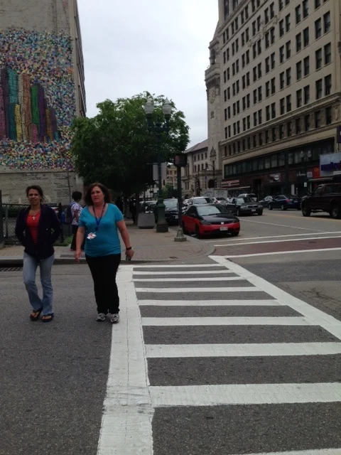 You can see these walkers on Main Street across from the Hanover Theater crossing Chatham Street. They waited awhile to get that light after hitting the walking button. In the area that has frequent pedestrian activity such as this, you can have automatic walk intervals to allow pedestrians to cross and make pedestrian activity more predictable. In fact, if the light on Main Street is green, walkers could have an automatic signal to cross. Technical terms for this kind of signaling is called, "concurrent pedestrian phase." Changing these signals could make a huge impact on the walkability of the city. Here is one more idea about making walking more pleasant on our city streets. Let's just stop the current "Barnes Dance" pedestrian scrambles. If you are a walker, you know this kind of signaling. You press the light, wait and wait until the signal is given and all directions of intersection traffic stop for the pedestrians. The problem: Both walkers and drivers are frustrated with the wait they are forced to endure because of this signaling. You know the drill. Press the button. Wait and wait and wait. Get impatient. Try to cross anyway. Cross. Light changes. All cars are stopped but you have already crossed so the traffic in all four directions stop for no reason. Frustration!