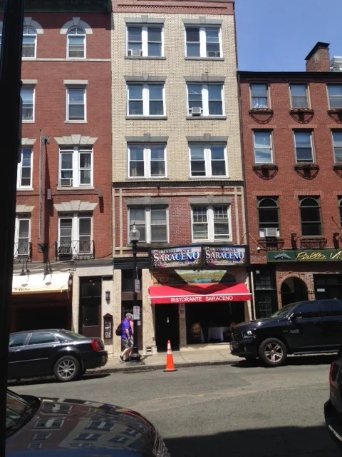 This is a classic example of Jane Jacobs type of mixed use - retail on the first floor and residential units up above. Note the small scale of the buildings. There are no skyscraper towers in this neighborhood as there are in Charles River Park. 
