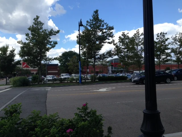 In 2006, Assembly Square Marketplace opened with the typical national big chain tenants – Staples, Christmas Tree Store, TJ Maxx, Bed Bath and Beyond, etc. You know this kind of development – Anywhere USA, a straight long row of huge big-box stores all set back from the street with mountains of surface lot parking out in front. 