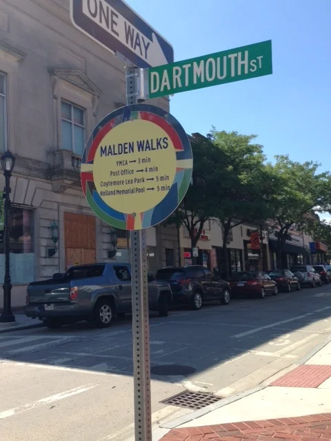 Check out the Wayfinding signage telling pedestrians where to go and how long it takes to get there. Worcester is supposed to have its own Wayfinding program in place soon. Can you imagine how great it will be to have strategically placed signs indicating how to get to places such as Union Station, the library, the YWCA, City Hall, etc. Wow! We could step up the notch in walkability if we entice visitors to walk easily from Union Station to the Worcester Art Museum! Another cool thing about Malden's interior roads: They are narrow, allow for metered parking on the side and have designated bike lanes. Here is another difference from Worcester: Malden did not seem to raze most of its historic, pre-automobile infrastructure in an urban renewal block-destroying frenzy. So, it has probably been easier to re-create these kind of human-scaled, walkable spaces there.