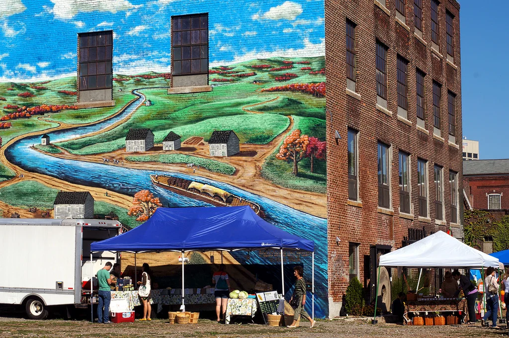 A bit of creative placemaking... This mural painted on the exterior back wall of Crompton Place depicts this neighborhood's connection to the waters of the Blackstone canal and river.