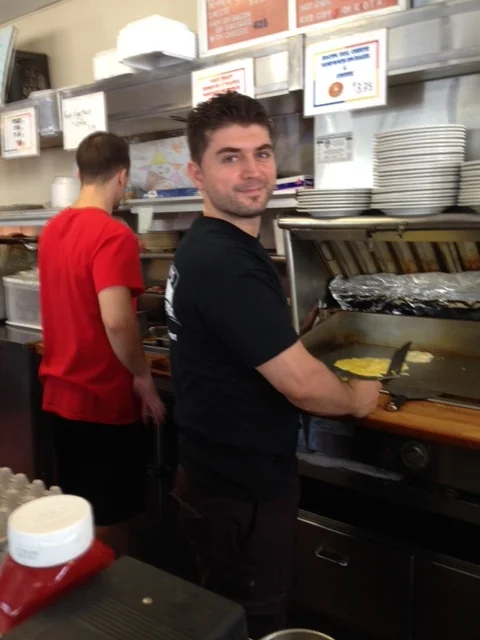 Originally from Albania, Tony is now a star at the grill. He can crack six eggs shotgun in the row with just his one hand. My son and I sit there mesmerized watching him cook so fast. “You make the best omelets,” I often tell him. He always gives Joseph a fist pump when he first greets him. “Hey, hey, hey!” Tony smiles as if he were happy we were there. ‘What’s up, little guy? What’s up, Joseph?”